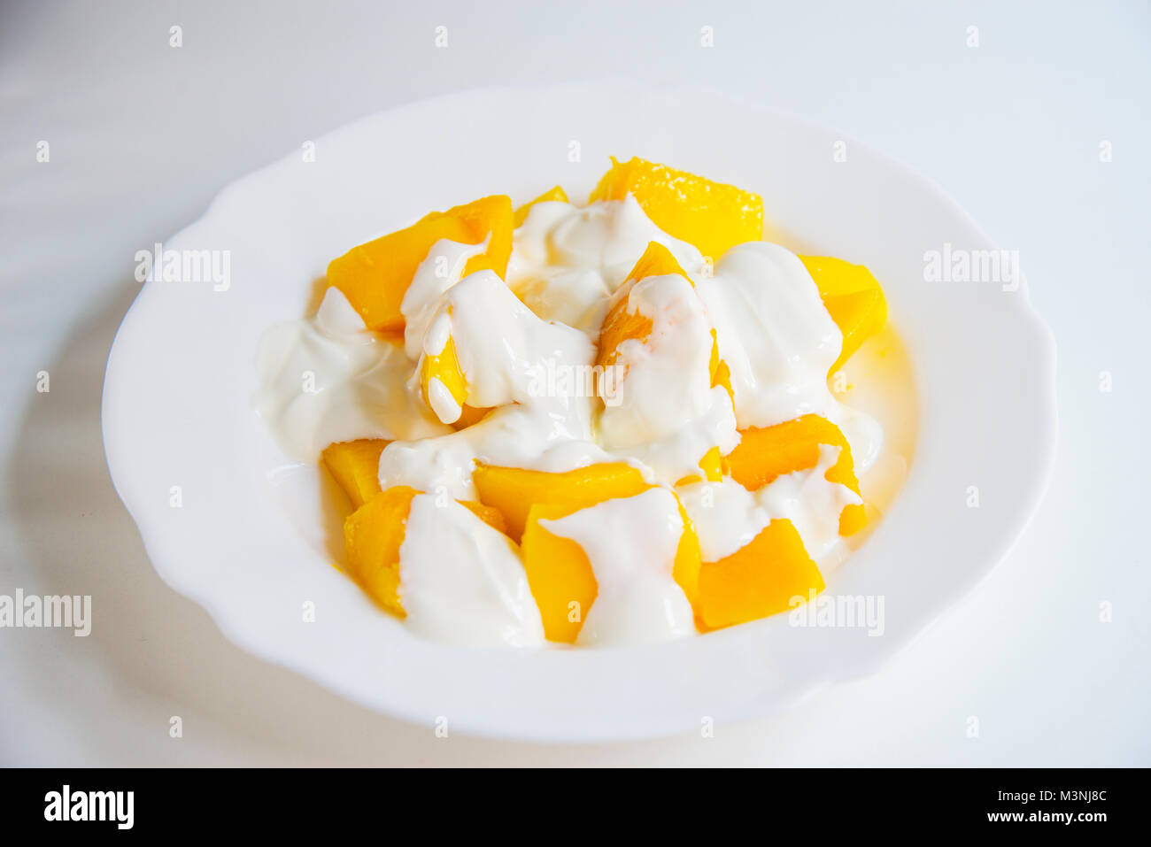 Mango with cream. Stock Photo