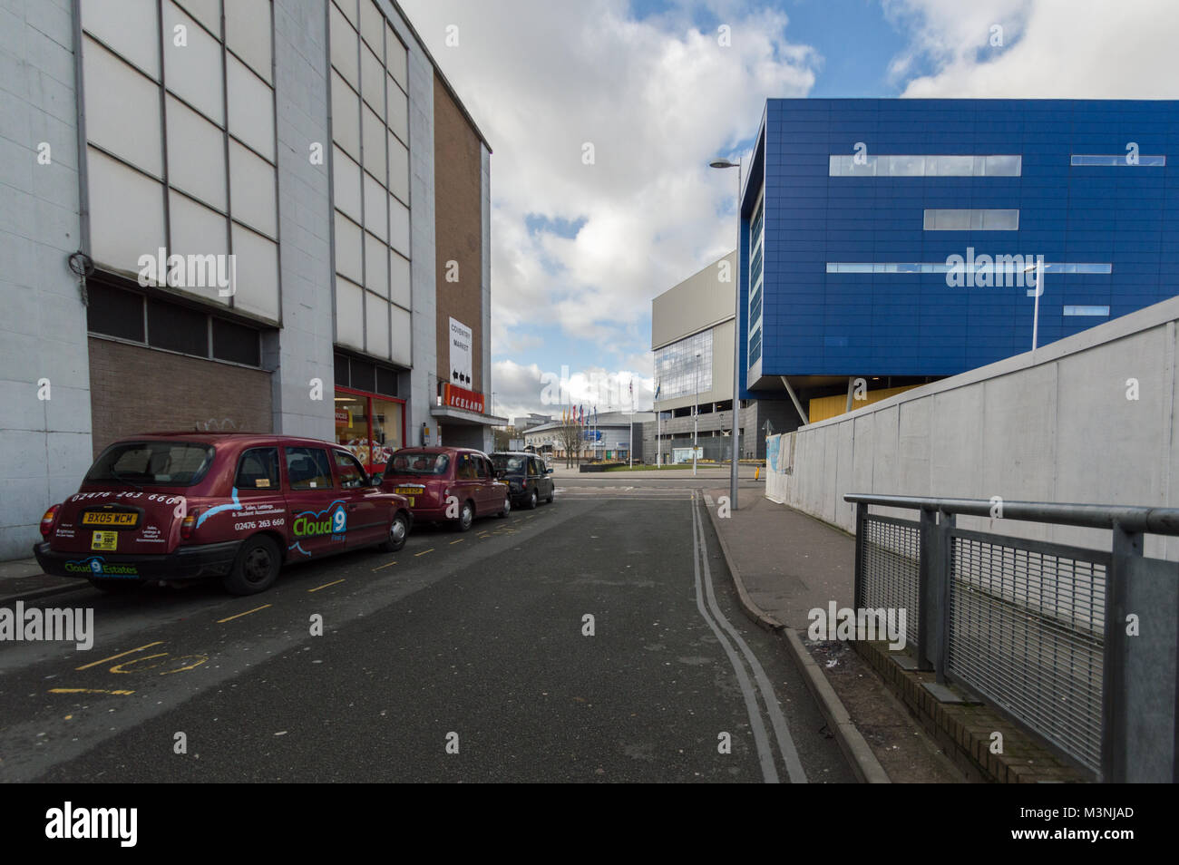 London Taxis parked outside Iceland supermarket shadowed by the Ikea building in Coventry City Centre Stock Photo