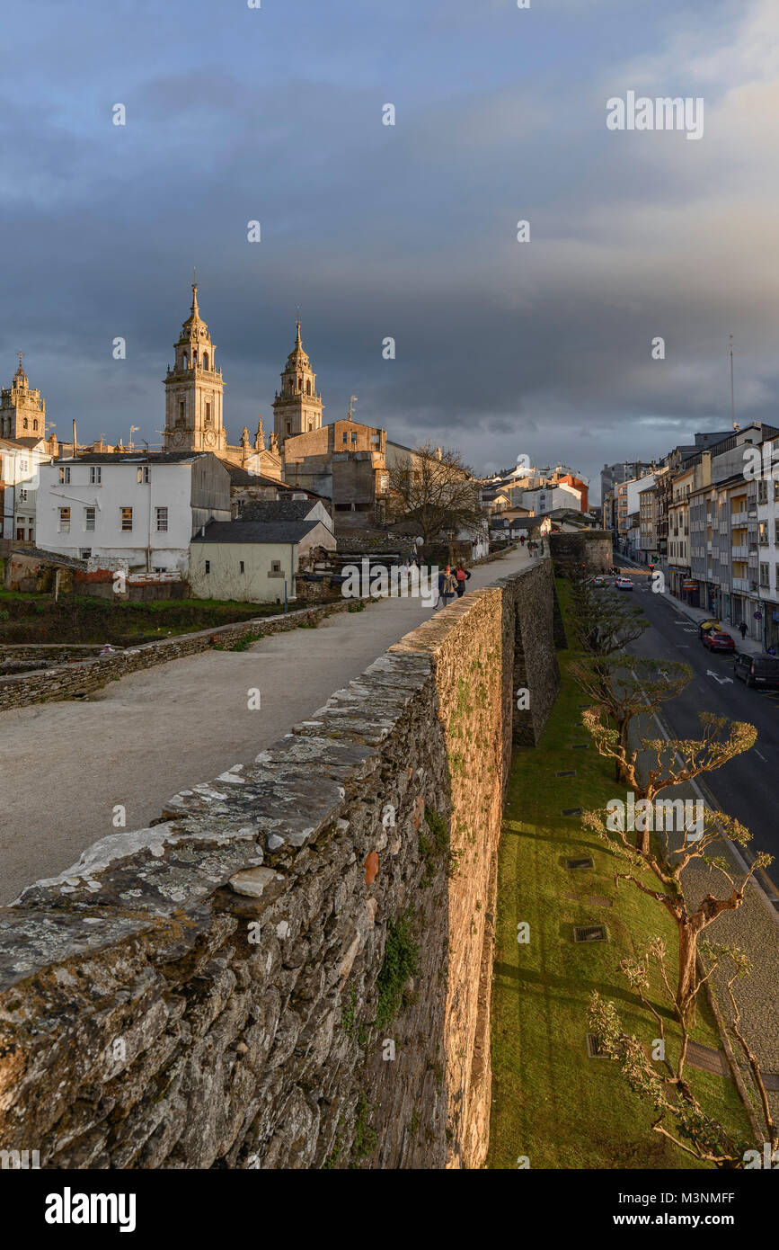 Cathedral of Santa Maria from the wall of the city of Lugo, Galicia region, Spain, illuminated in the sunset Stock Photo