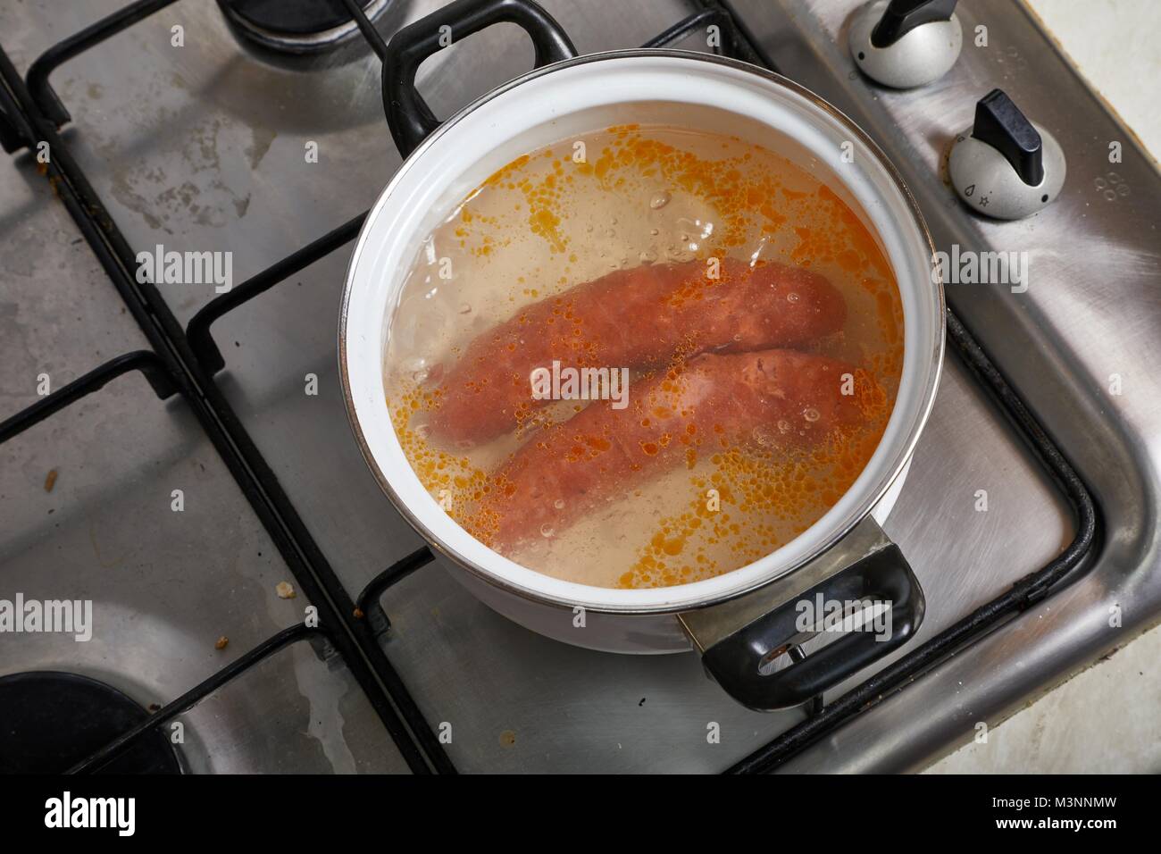 Boiling sausages on stove Stock Photo Alamy