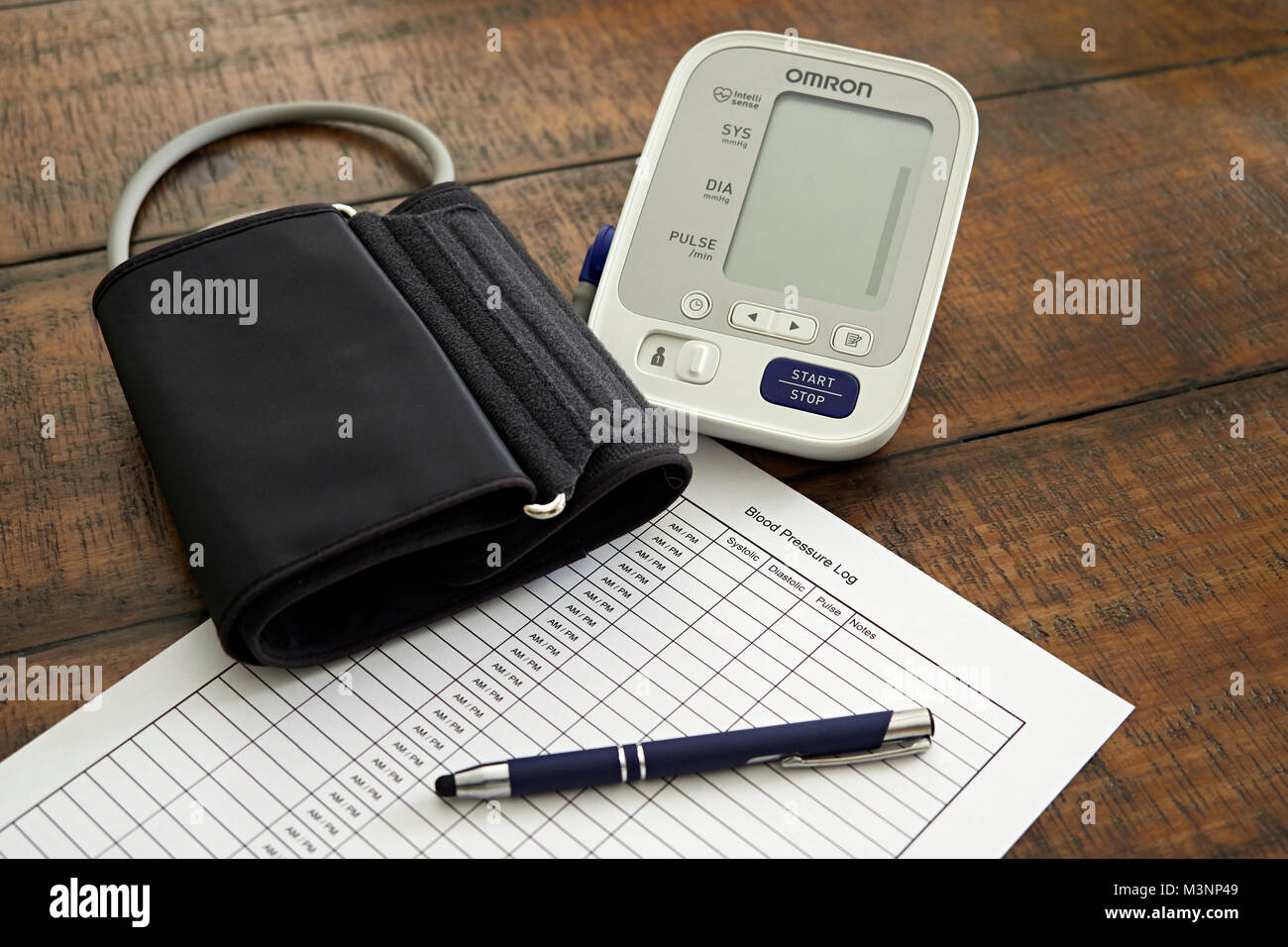 Sphygmomanometer or blood pressure monitor, cuff, and chart ready to monitor heart health.  Concept of healthy lifestyle. Stock Photo