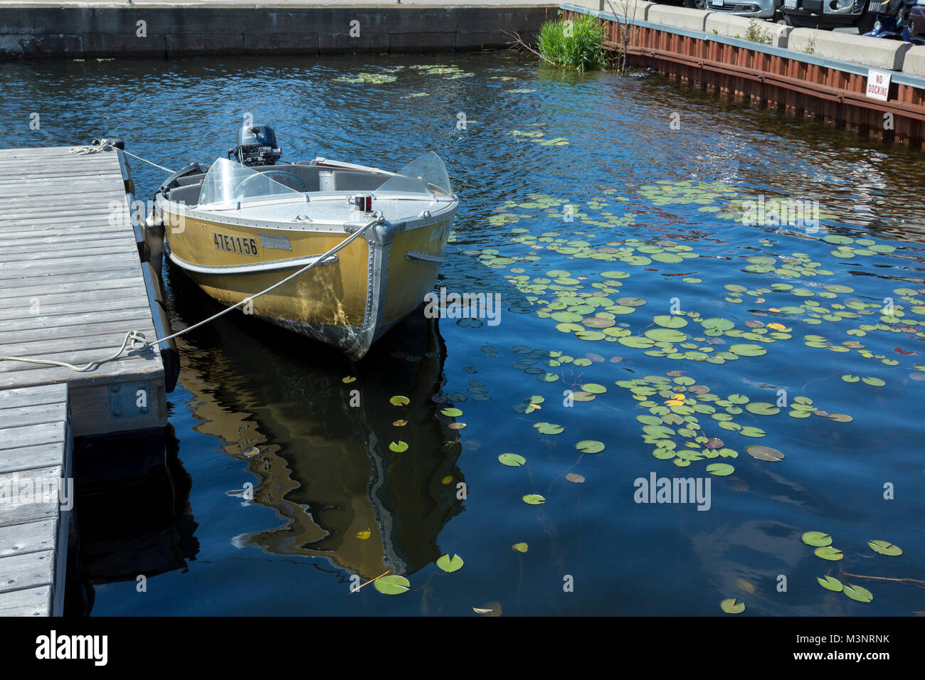 Classic small yellow fishing boat surrounded by Lilly pads sunny summer day Parry Sound Georgian Bay National Park Ontario Canada Stock Photo