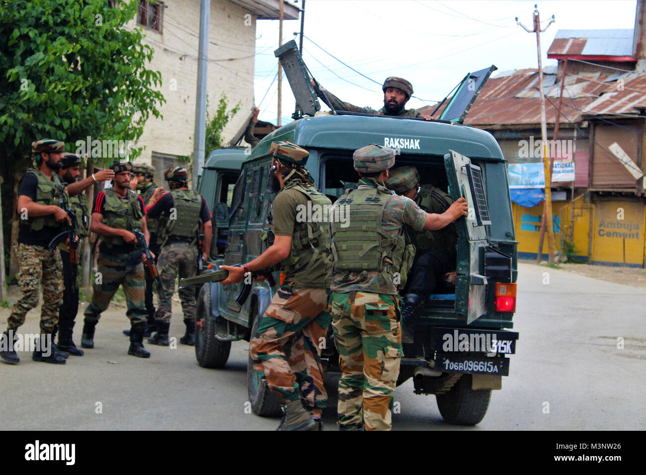 Army man with automatic rifle, Sopore town, Kashmir, India, Asia Stock Photo