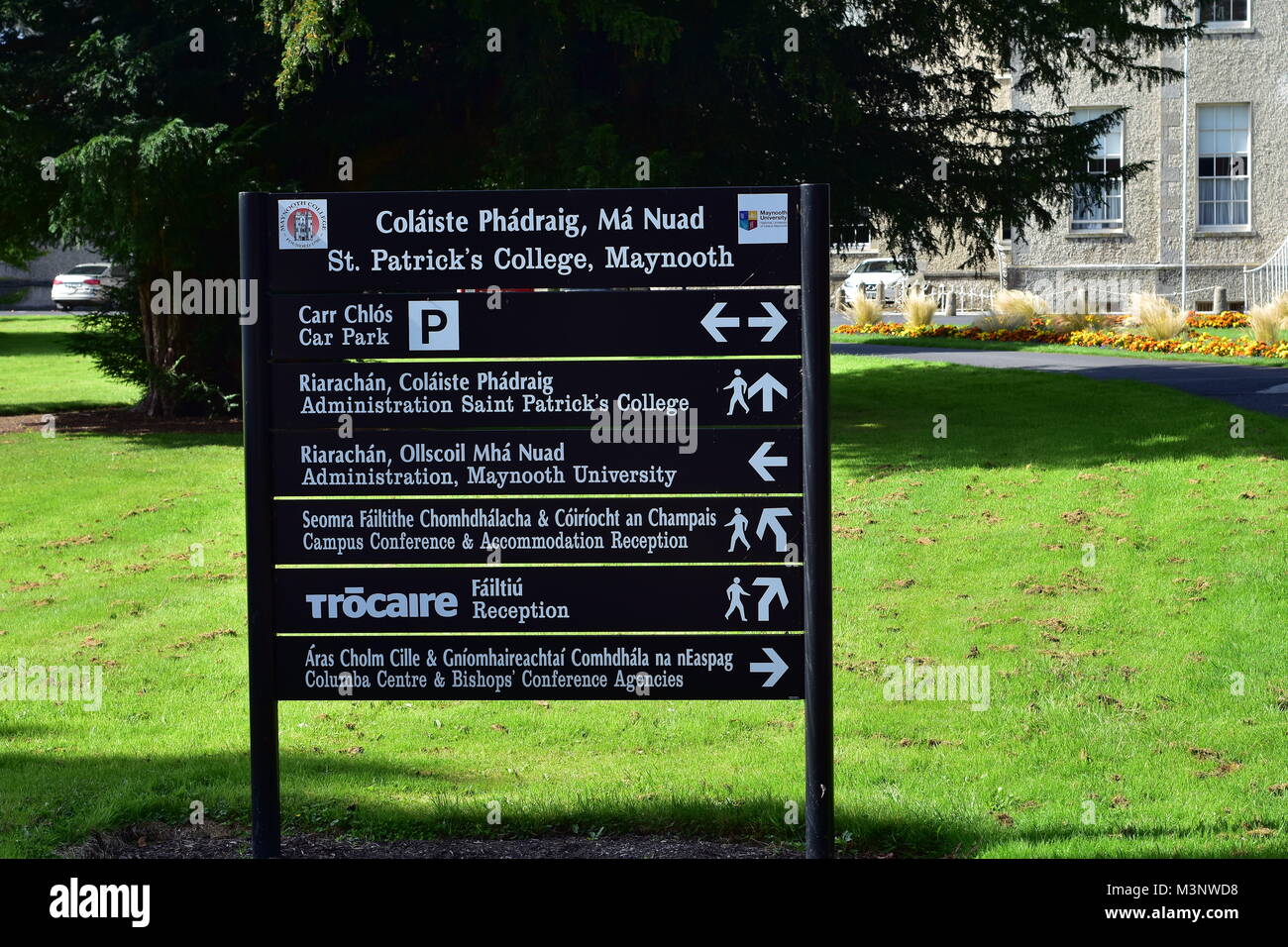 Directions sign in front of administration building of St Patrick's College in university town of Maynooth in Ireland. Stock Photo