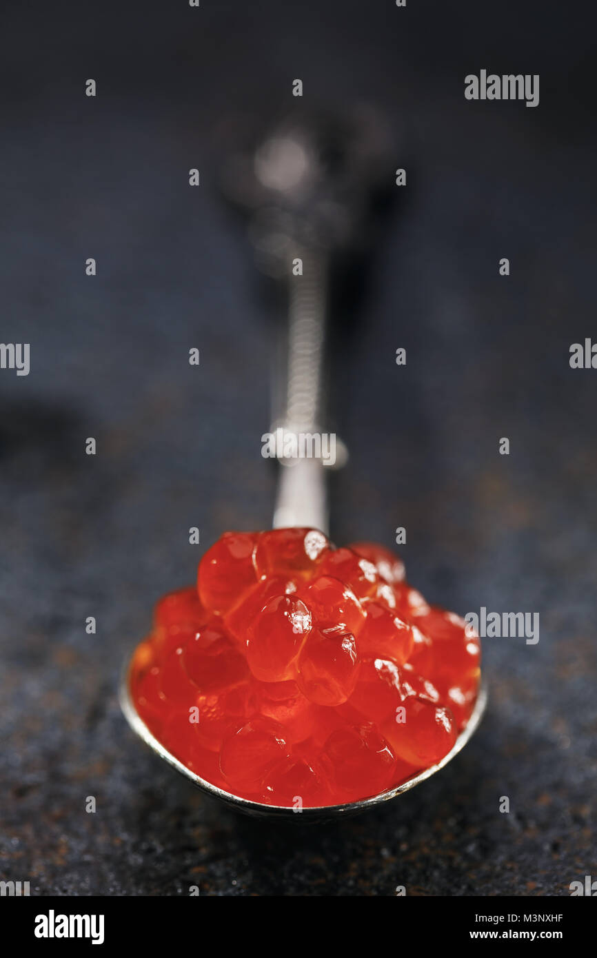 Spoon of red caviar on the table, close-up Stock Photo