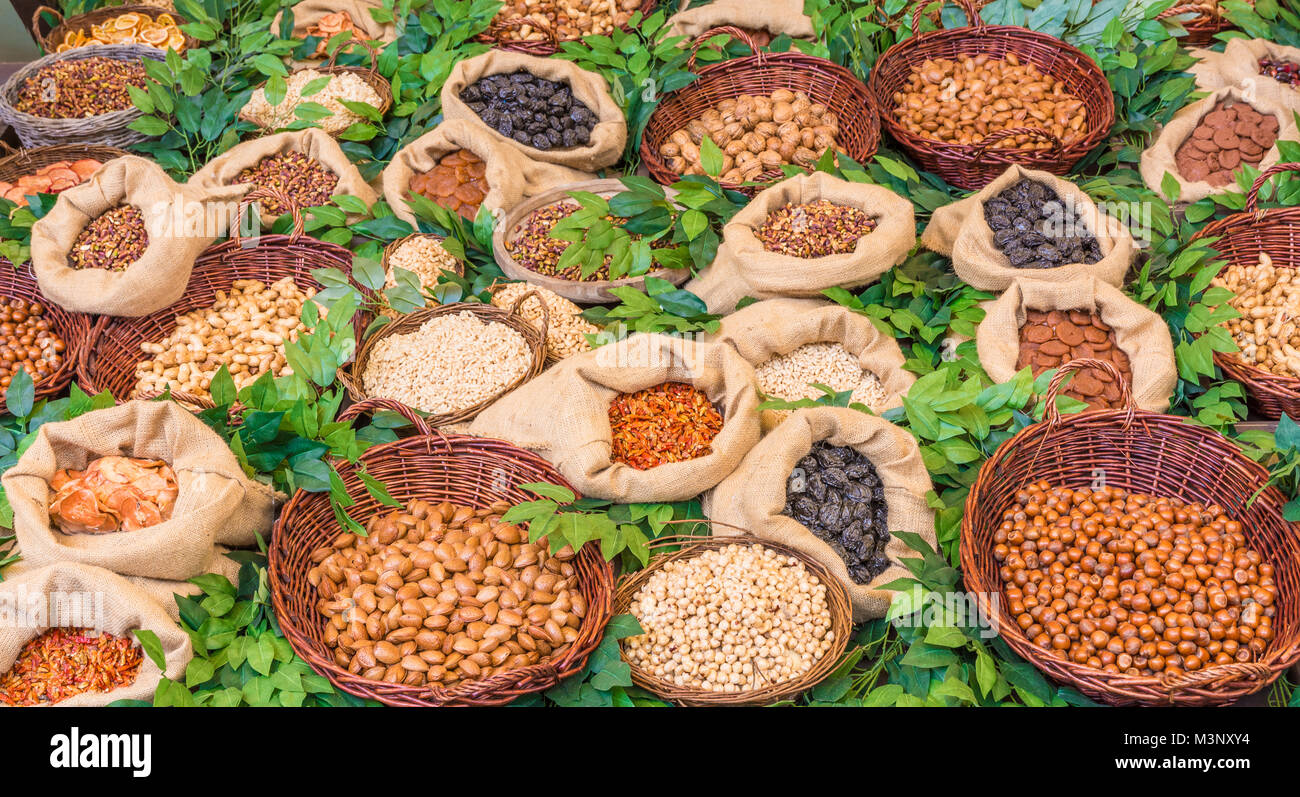 Healthy food: assortment of dried fruit in vintage wooden containers. Decoration with laurel. Stock Photo