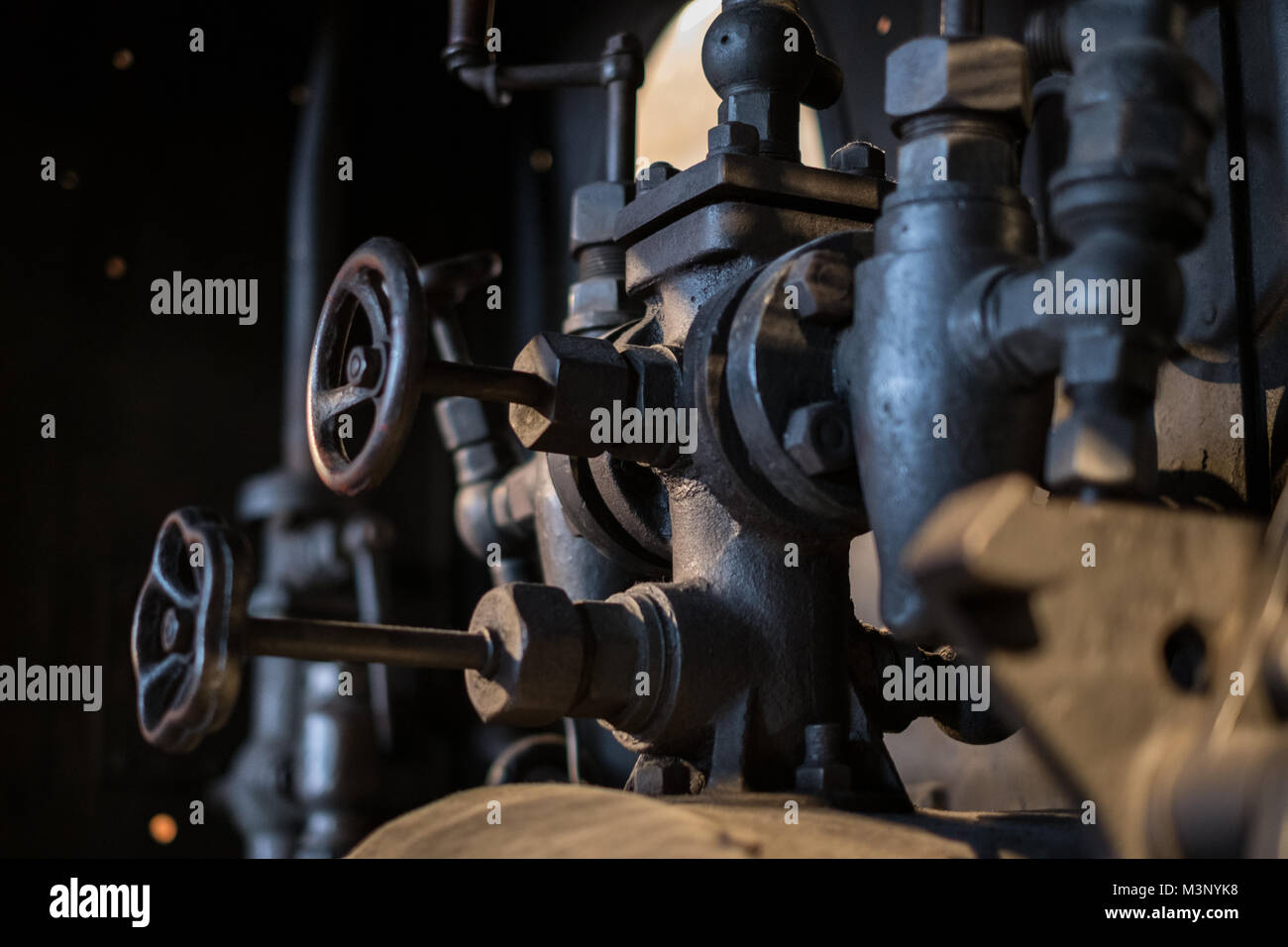 vintage technology, pipes and valves inside old factory - Stock Photo