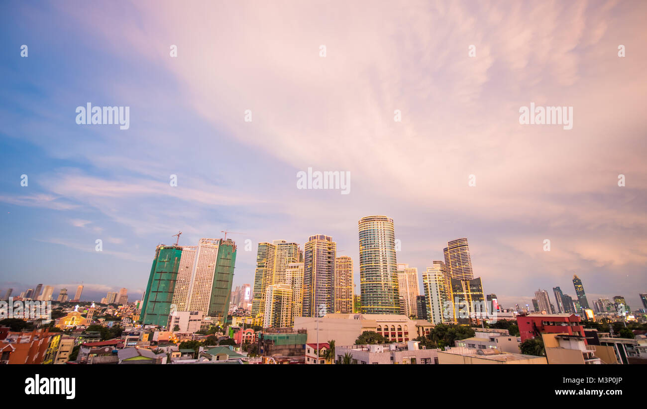 The capital of the Philippines is Manila. Makati city. Beautiful sunset with thunderous powerful clouds. Stock Photo