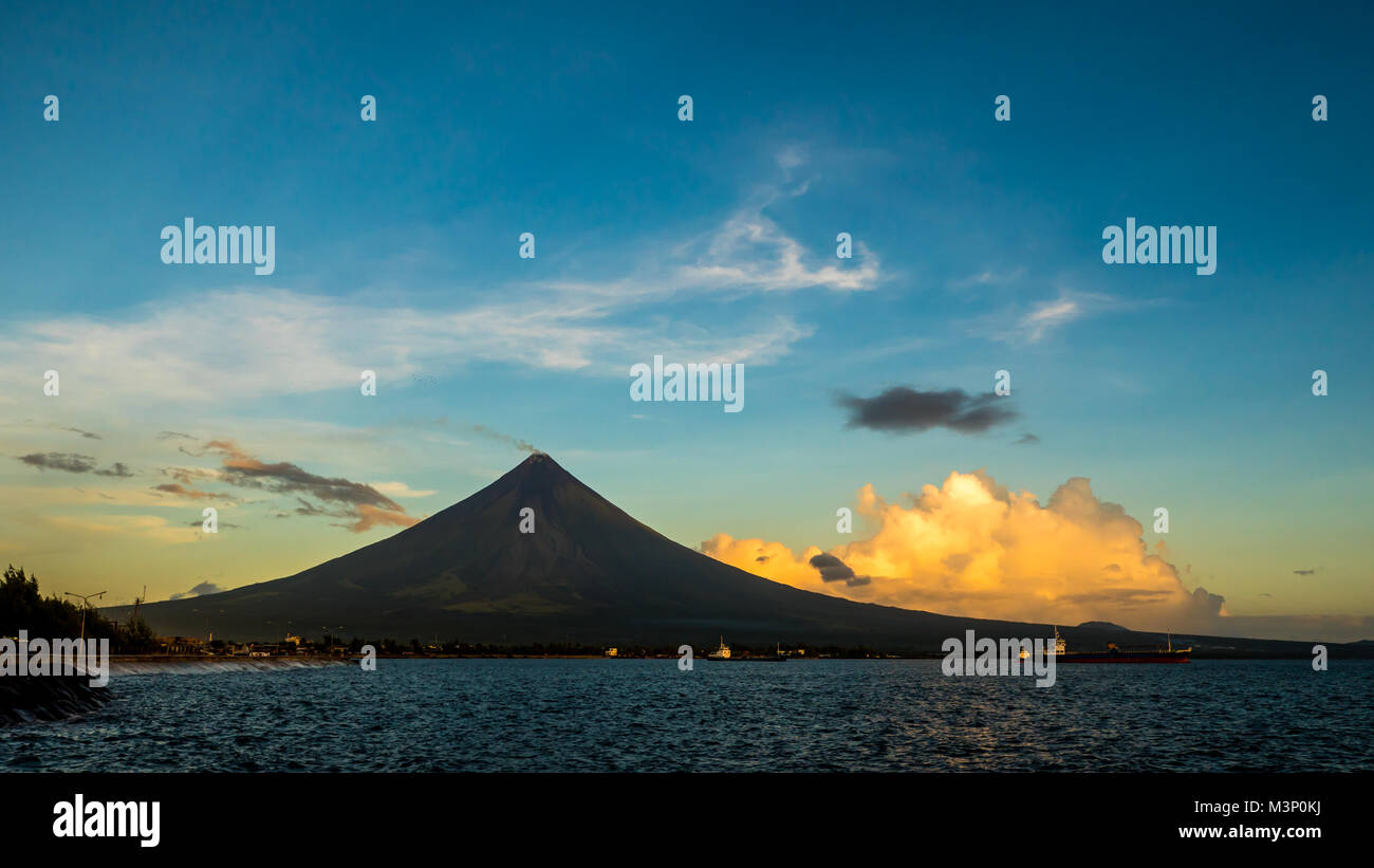 Silhouette Mayon Volcano is an active stratovolcano in the province of Albay in Bicol Region, on the island of Luzon in the Philippines. Renowned as the perfect cone because of its symmetric conical shape. Stock Photo