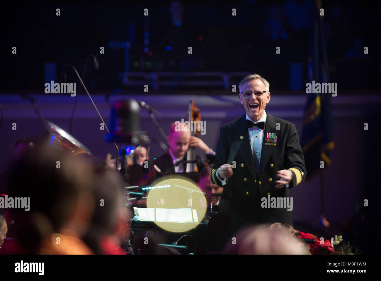 171216-N-VV903-1042 WASHINGTON (Dec. 16, 2017) Captain Kenneth Collins leads the  U.S. Navy Band during a holiday concert at DAR Constitution Hall in Washington. The Navy Band hosted thousands of people from the Washington area as well as hundreds of senior Navy and government officials during its three annual holiday concerts. (U.S. Navy photo by Musician 1st Class David Aspinwall/Released) 171216-N-VV903-1042 by United States Navy Band Stock Photo