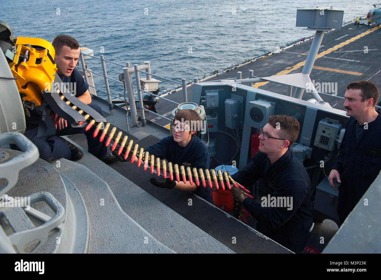 171220-N-HT134-072 INDIAN OCEAN (Dec. 20, 2017) Sailors assigned to the command, control, communications, computers, collaboration and intelligence department aboard the amphibious assault ship USS America (LHA 6) load the forward closed-in weapons system with 20mm rounds in preparation for a live exercise. America, part of the America Amphibious Ready Group, with embarked 15th Marine Expeditionary Unit, is operating in the Indo-Asia Pacific region to strengthen partnerships and serve as a ready-response force for any type of contingency. (U.S. Navy photo by Mass Communication Specialist Seama Stock Photo