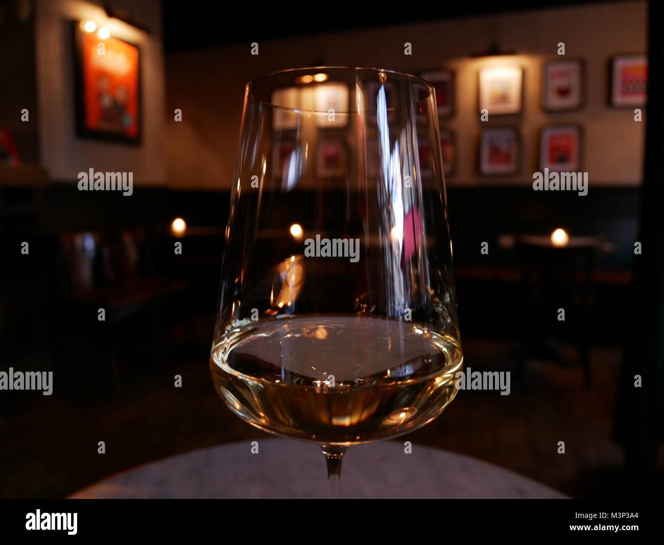 A glass of white wine in a top London wine bar. Stock Photo