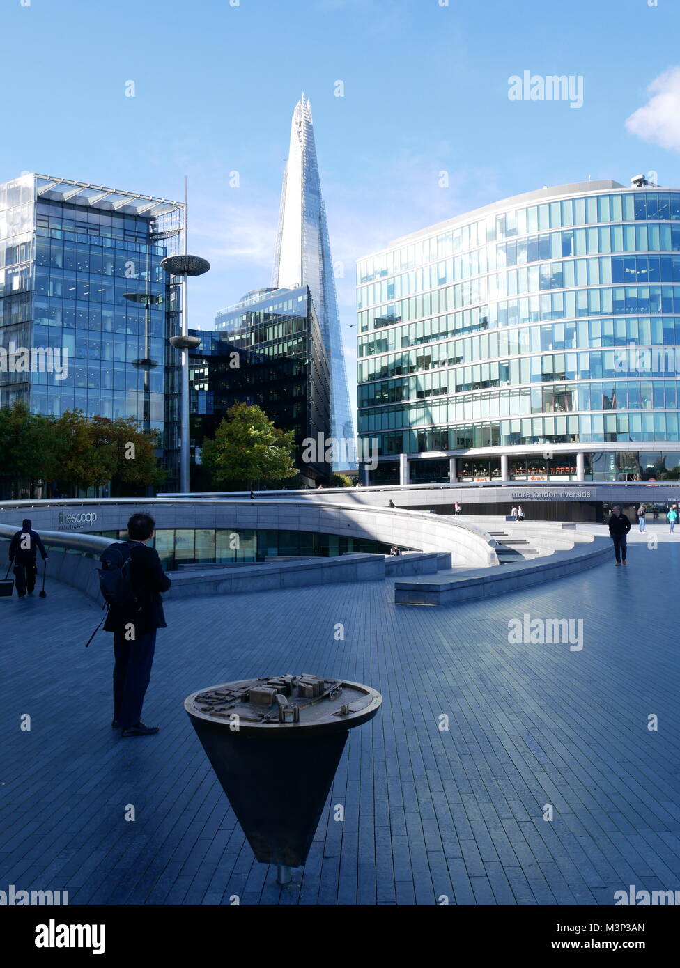 Tourist and glass office buildings in London with a view of The Shard. Stock Photo