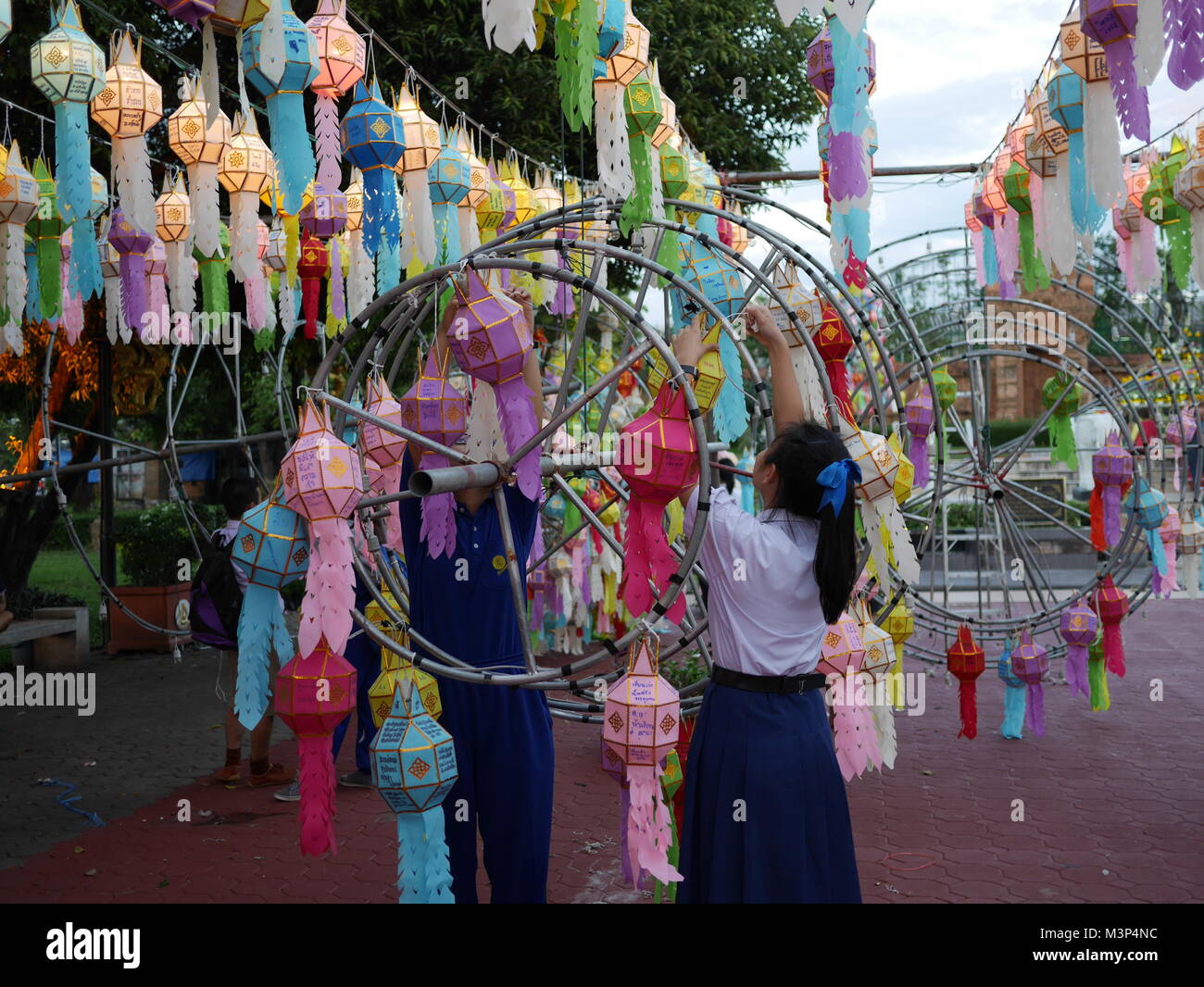Thai Students hanging lanterns during Loi Krathong Festival celebrations, Lamphun, Thailand Stock Photo