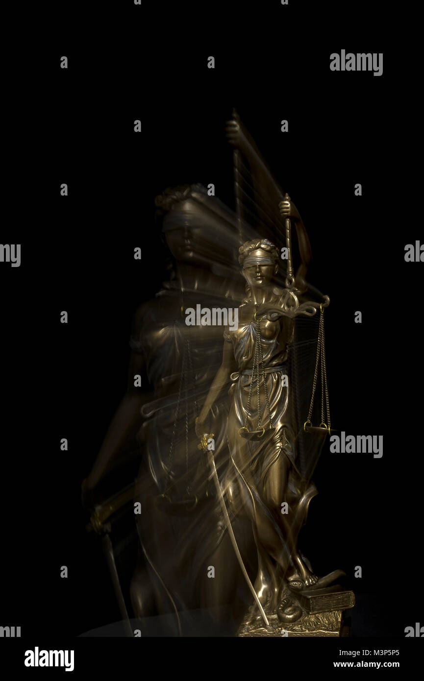 Unclear legal situation - Justitia statue in blurred zoom effect in front of black background Stock Photo