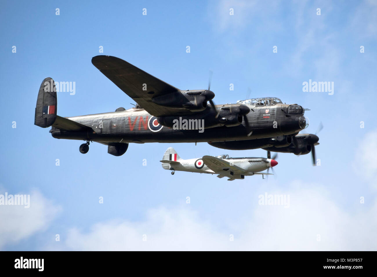 Avro Lancaster ans Supermarine Spitfire in close formation over Lincolnshire, UK. Stock Photo
