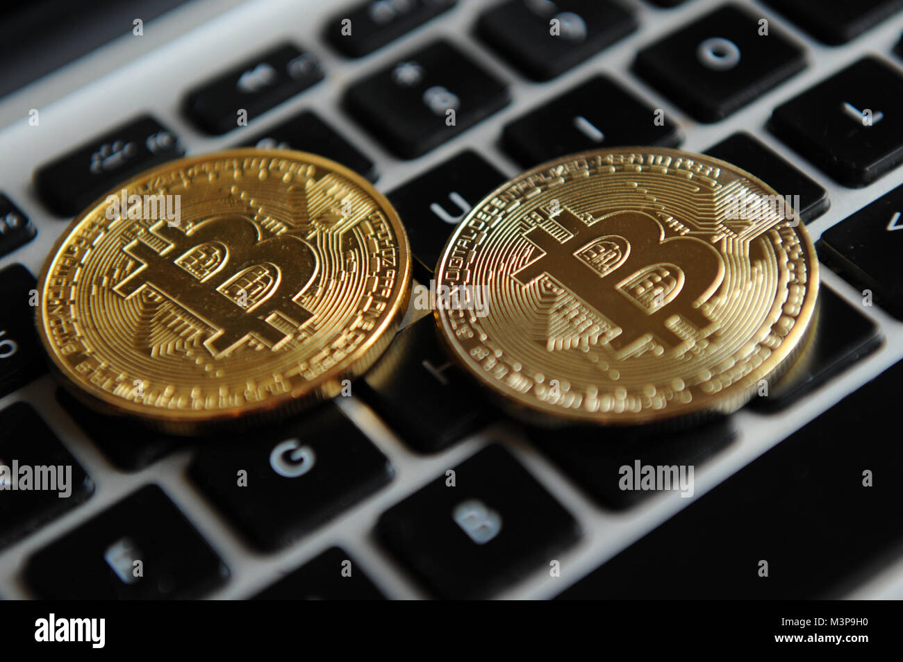 Bitcoins on a computer keyboard Stock Photo