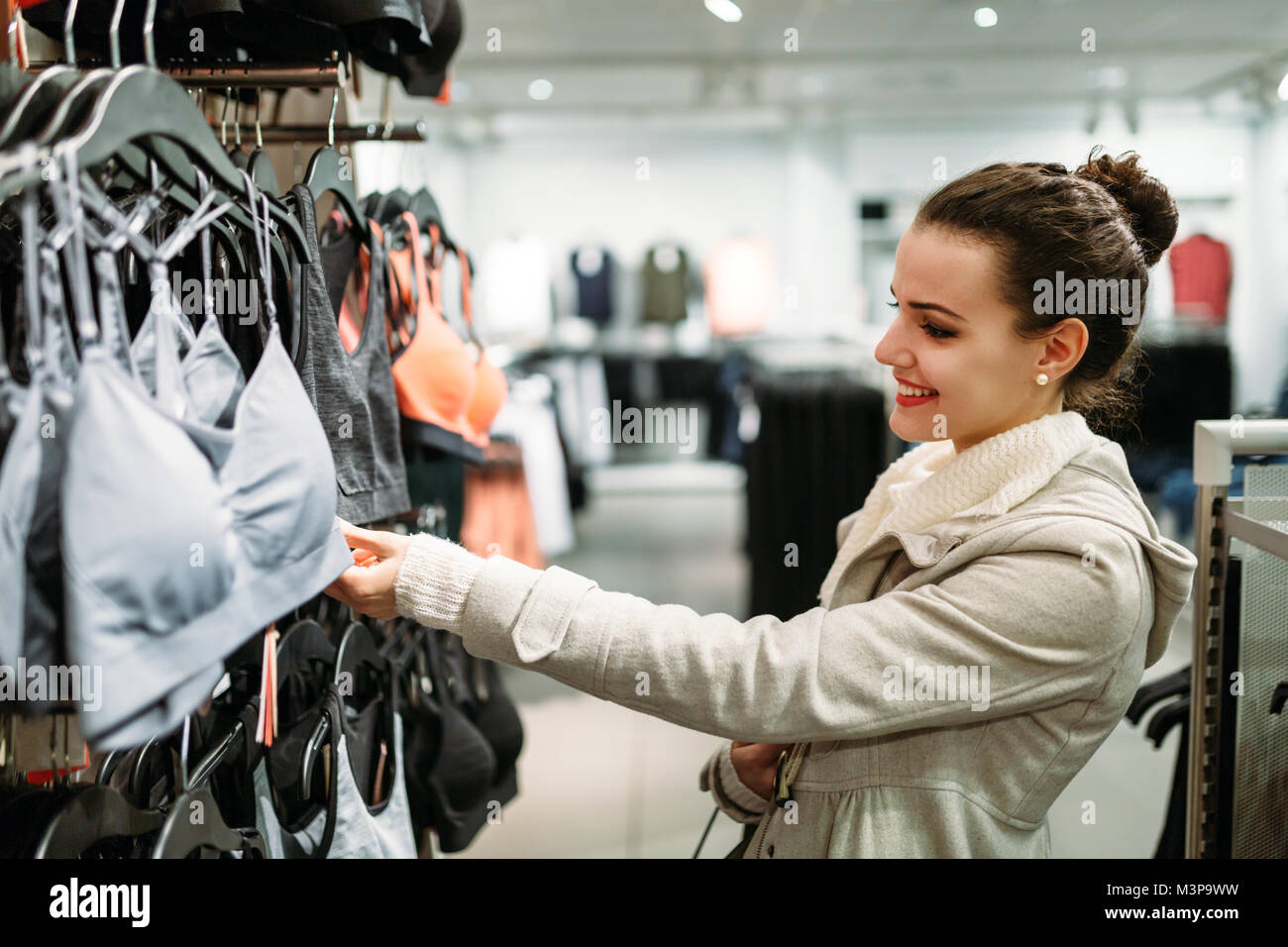 Cheerful Positive Female With Packs And Girl Buying Clothes In The Dress  Shop Stock Photo, Picture and Royalty Free Image. Image 84950579.