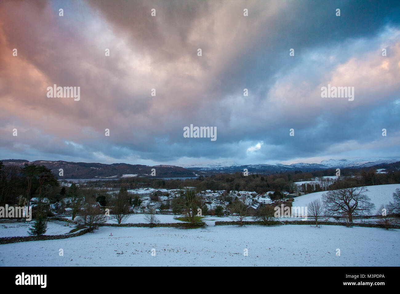 A winter sunrise over the village of Troutbeck Bridge on the banks of Lake Windermere, Cumbria, England, Uk Stock Photo