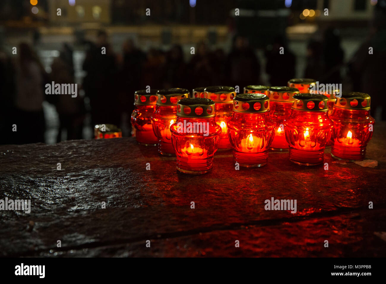 Moscow, Russia. 12th February, 2018. Candles are placed to mourn the victims in the AN-148 passenger jet crash near the Cathedral of Christ the Saviour in Moscow, Russia, on Feb. 12, 2018. Rescuers have presumably recovered the second flight data recorder of the AN-148 passenger jet that crashed in the Moscow region on Sunday, the Russian Emergencies Ministry said Monday. cl Credit: Xinhua/Alamy Live News Stock Photo
