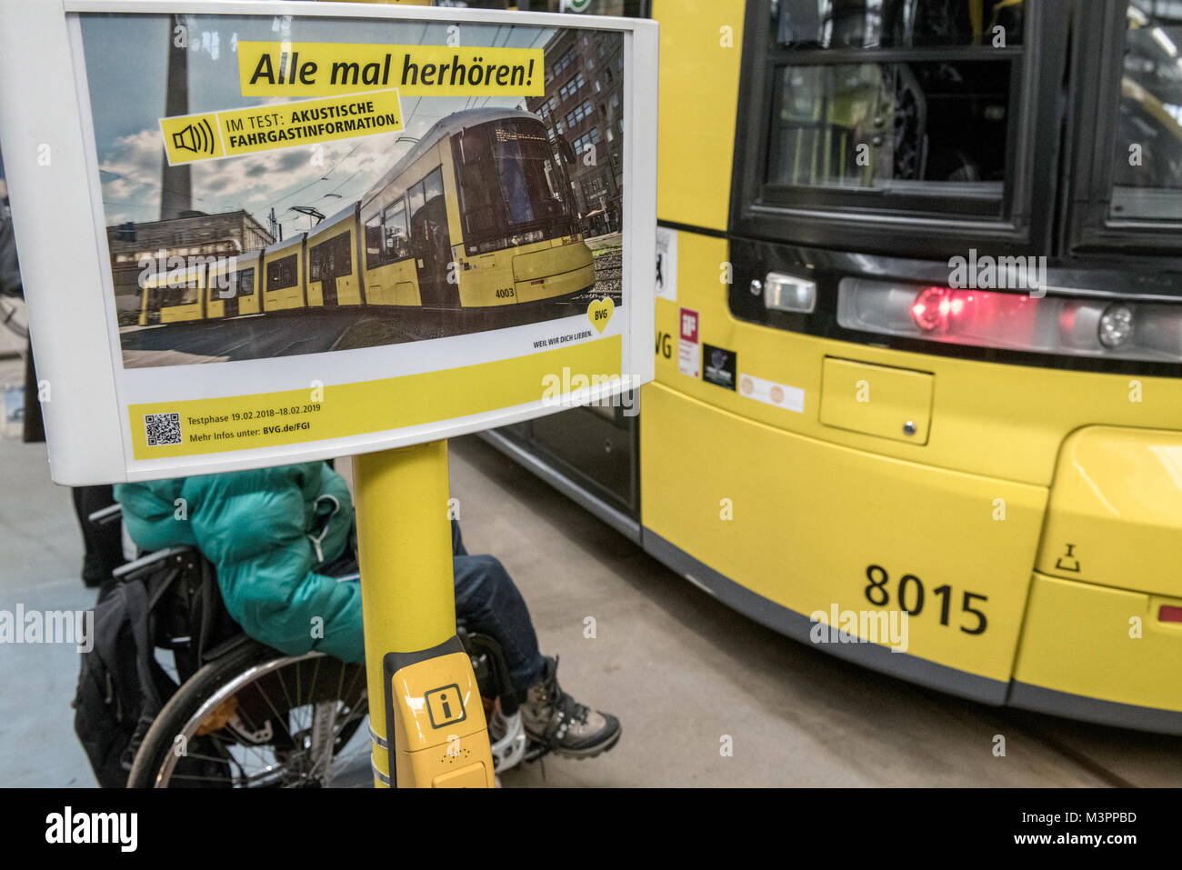 Berlin, Germany. 12th Feb, 2018. A temporarily set up tram stop reads 'Alle mal herhoeren!' (lit. everybody listen) at the press event of the Berliner Verkehrsbetriebe (BVG) (lit. Berlin Transport Company) in a hall of the depot Lichtenberg in Berlin, Germany, 12 February 2018. The BVG presented the project 'Barrierefreiheit für blinde und sehbehinderte Fahrgaeste' (lit. Accessibility for blind and visually impaired passengers). Credit: Paul Zinken/dpa/ZB/dpa/Alamy Live News Stock Photo