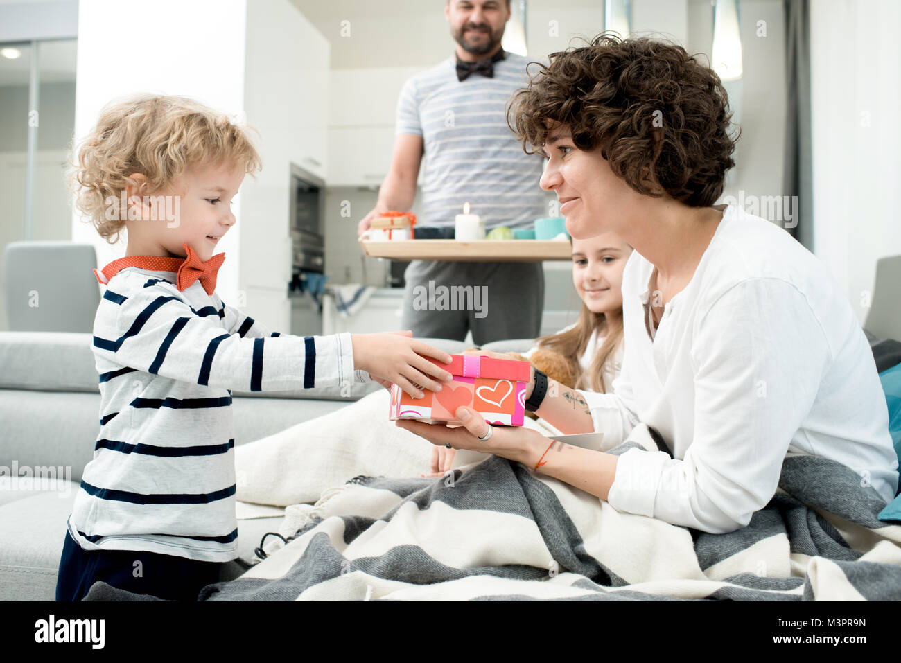 Little Boy Giving Presents to Parents Stock Photo
