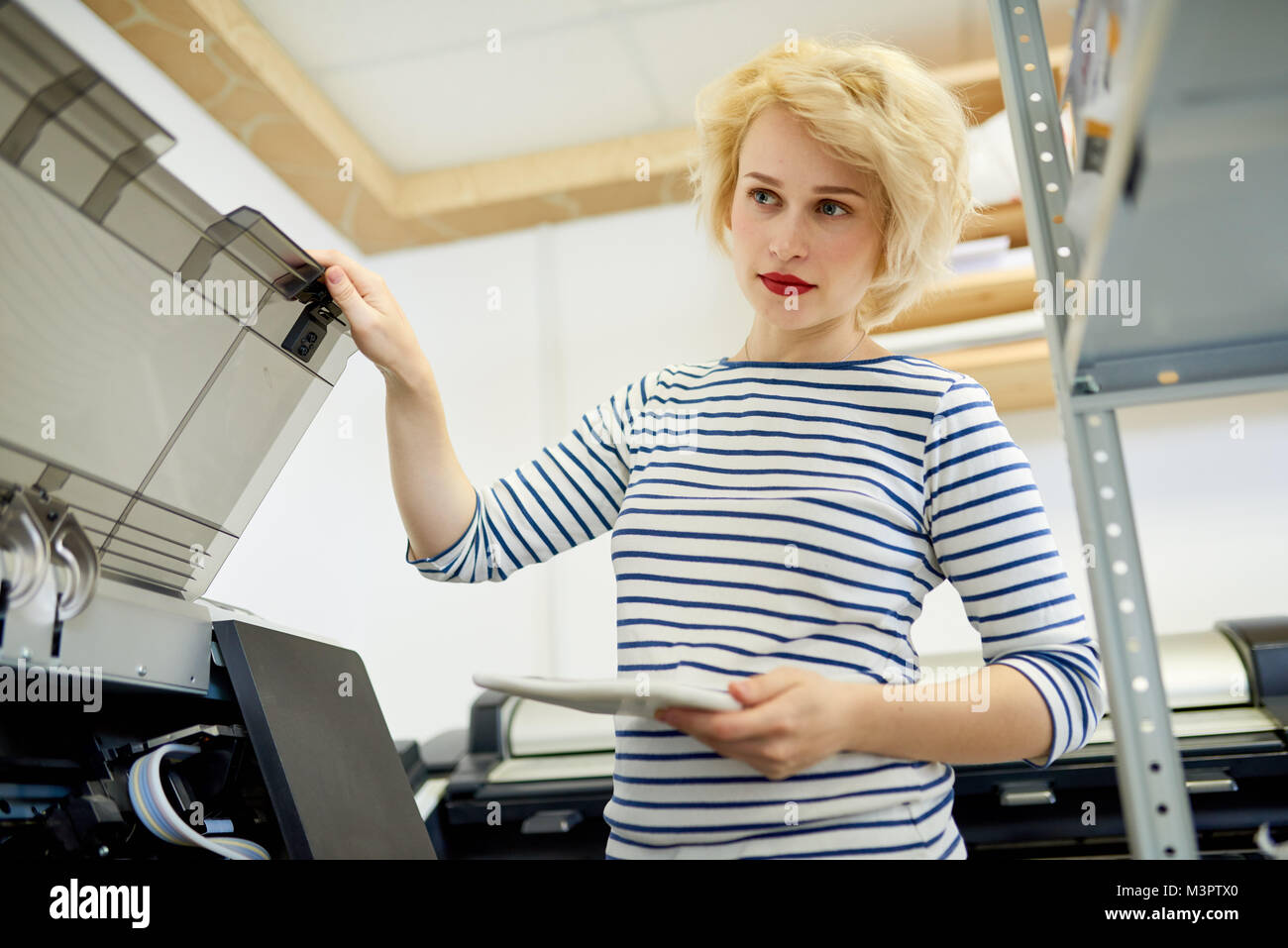 Woman Using Copy Machine Stock Photo