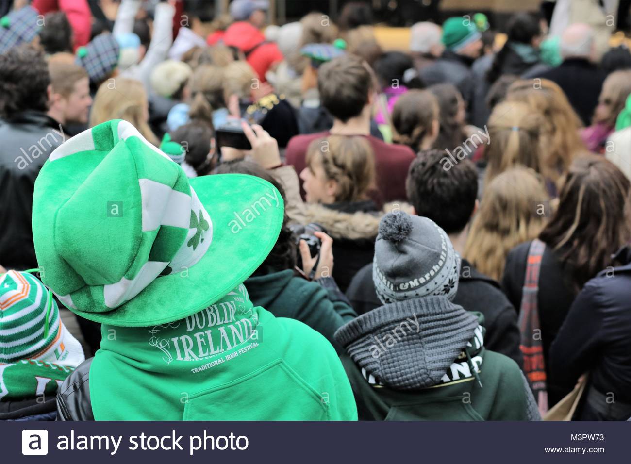 Green hat, green sweatshirt, green everywhere as the St Patrick's day festival begins in Dublin, Ireland. Stock Photo