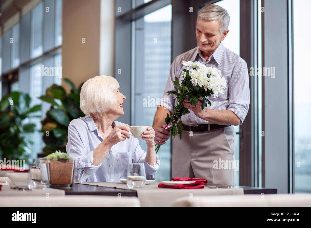 Tender mature couple dating at restaurant Stock Photo - Alamy