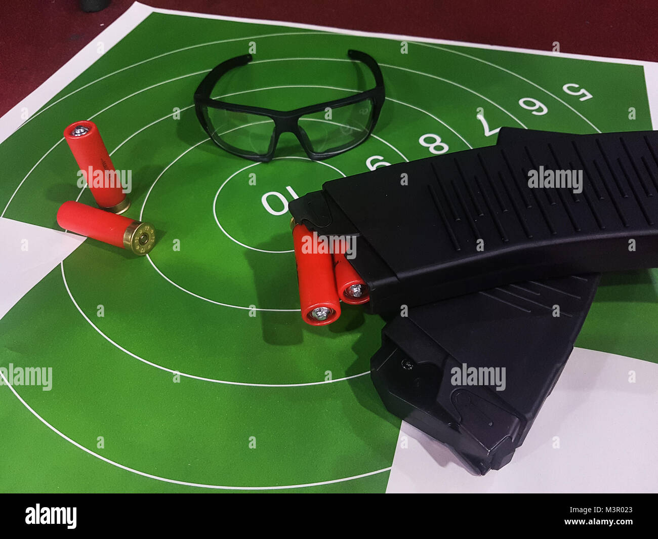 Picture of shooting gallery with target, glasses, gun Stock Photo Alamy