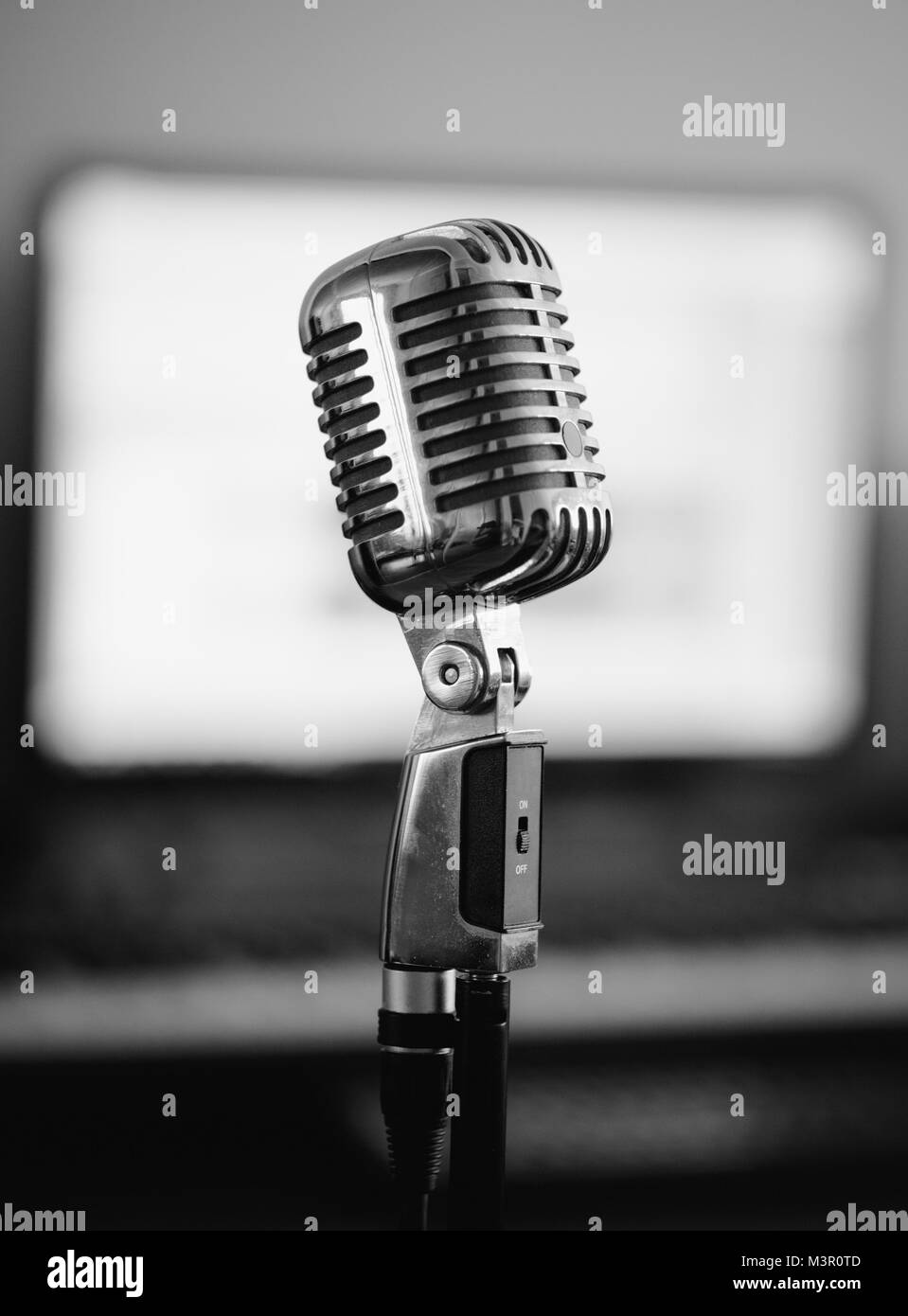 Retro microphone in home studio. Black and white. Stock Photo