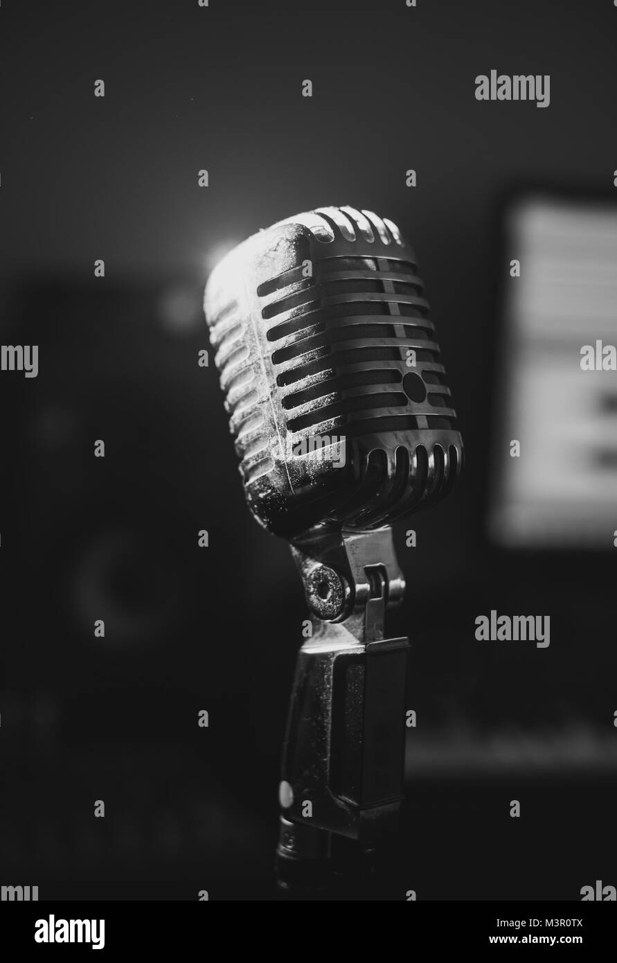 Retro microphone in home music studio. Black and white. Stock Photo