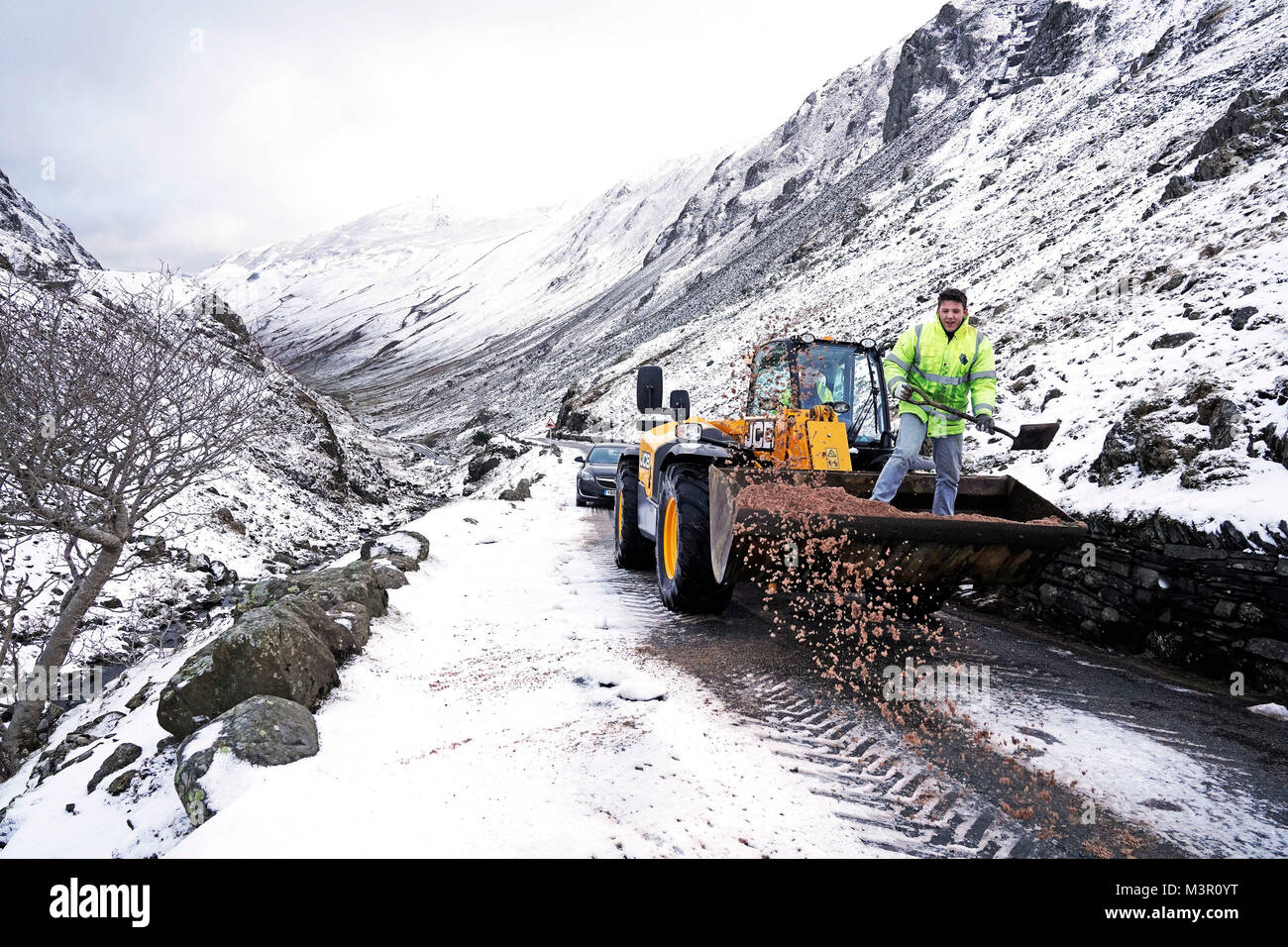 A tractor clears snow from a road near Honister Slate Mine in the lake district, Cumbria, as commuters faced icy conditions on Monday morning, with heavy snow expected in parts of Scotland amid warnings of vehicles becoming stranded on roads. Stock Photo
