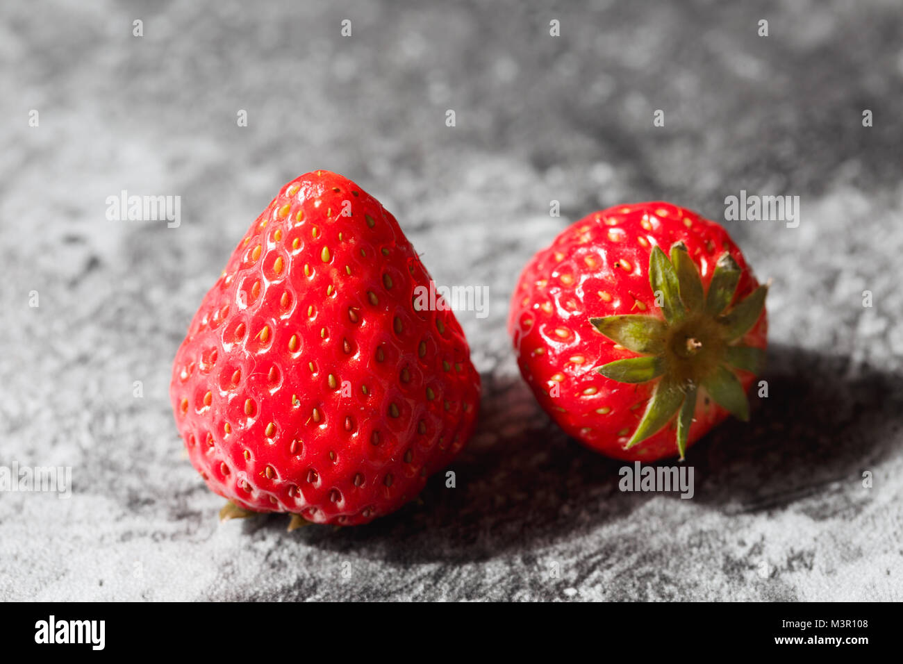 The red strawberry is in the dark background Stock Photo - Alamy