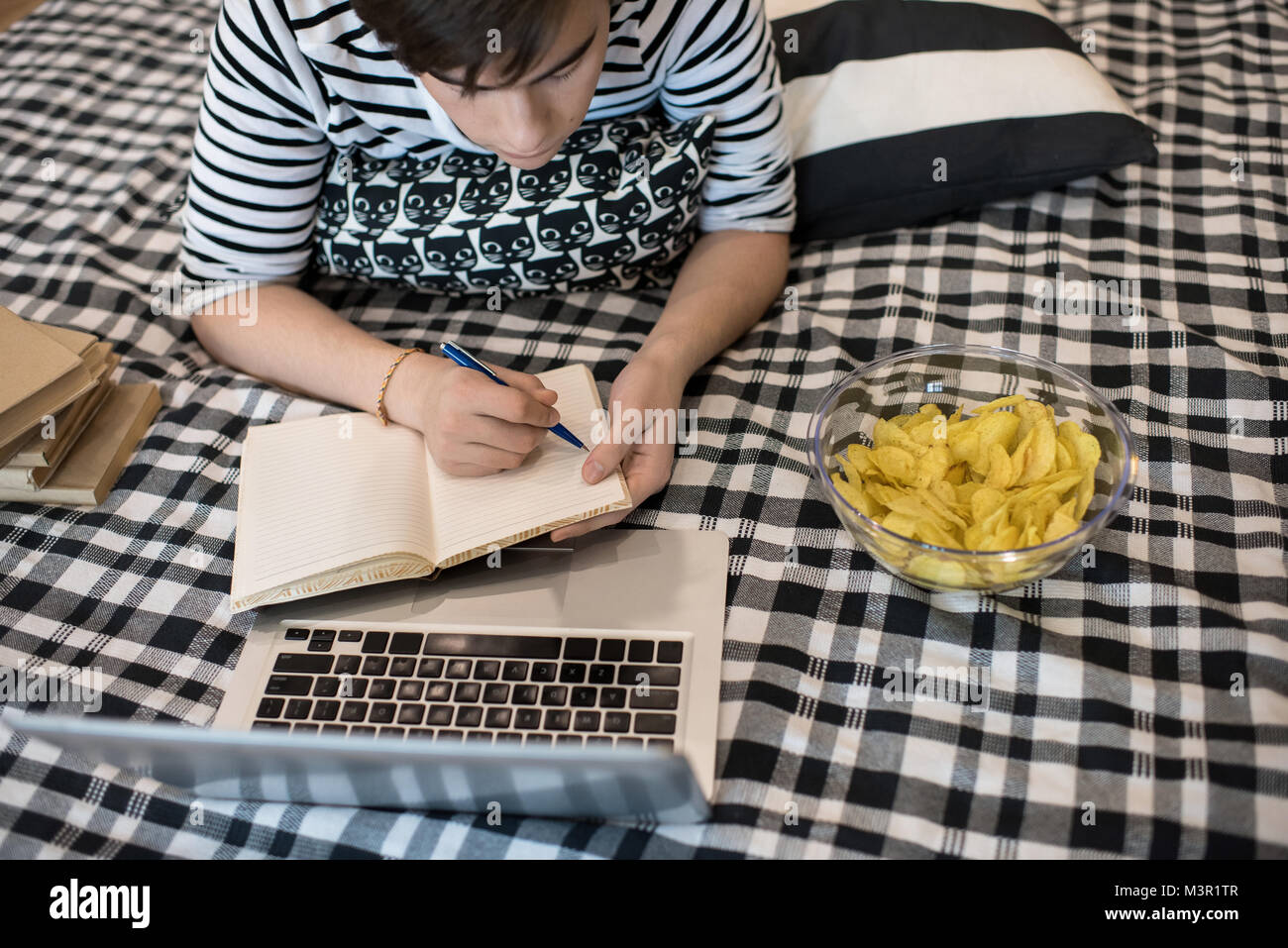 Boy Doing Homework on Bed Stock Photo Alamy