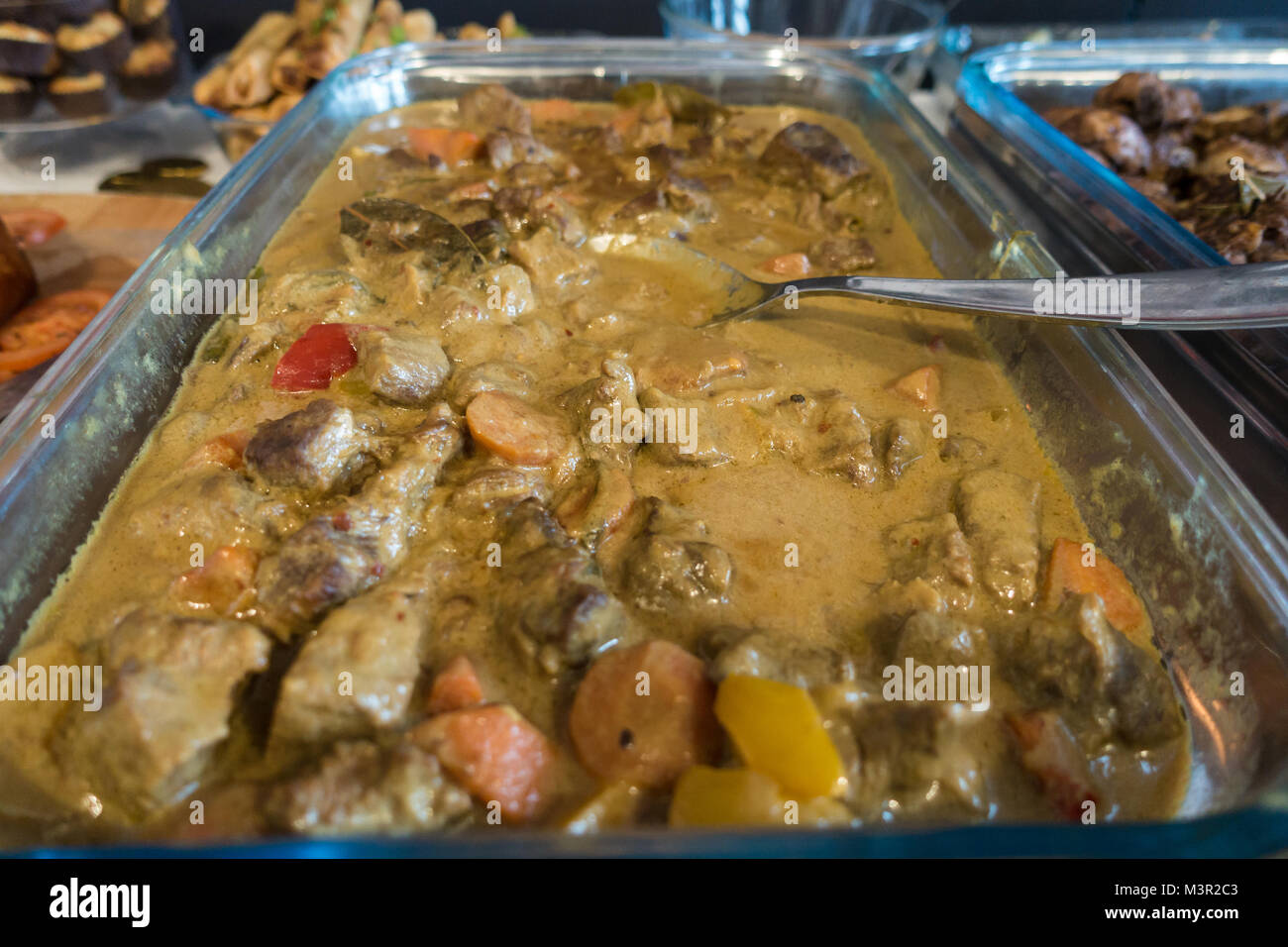 A large dish of beef rendang, an Asiann dish form Malaysia and The Philippines. Stock Photo