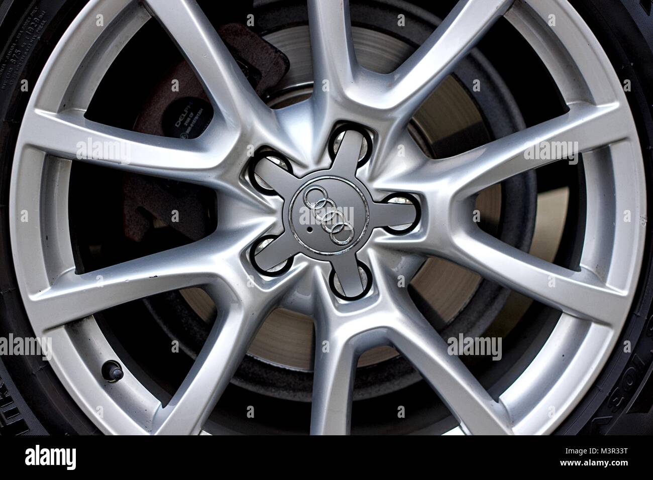 Tire, wheels and brake parts of compact luxury crossover SUV Audi Q5 2.0 TDI quattro S tronic. Stock Photo