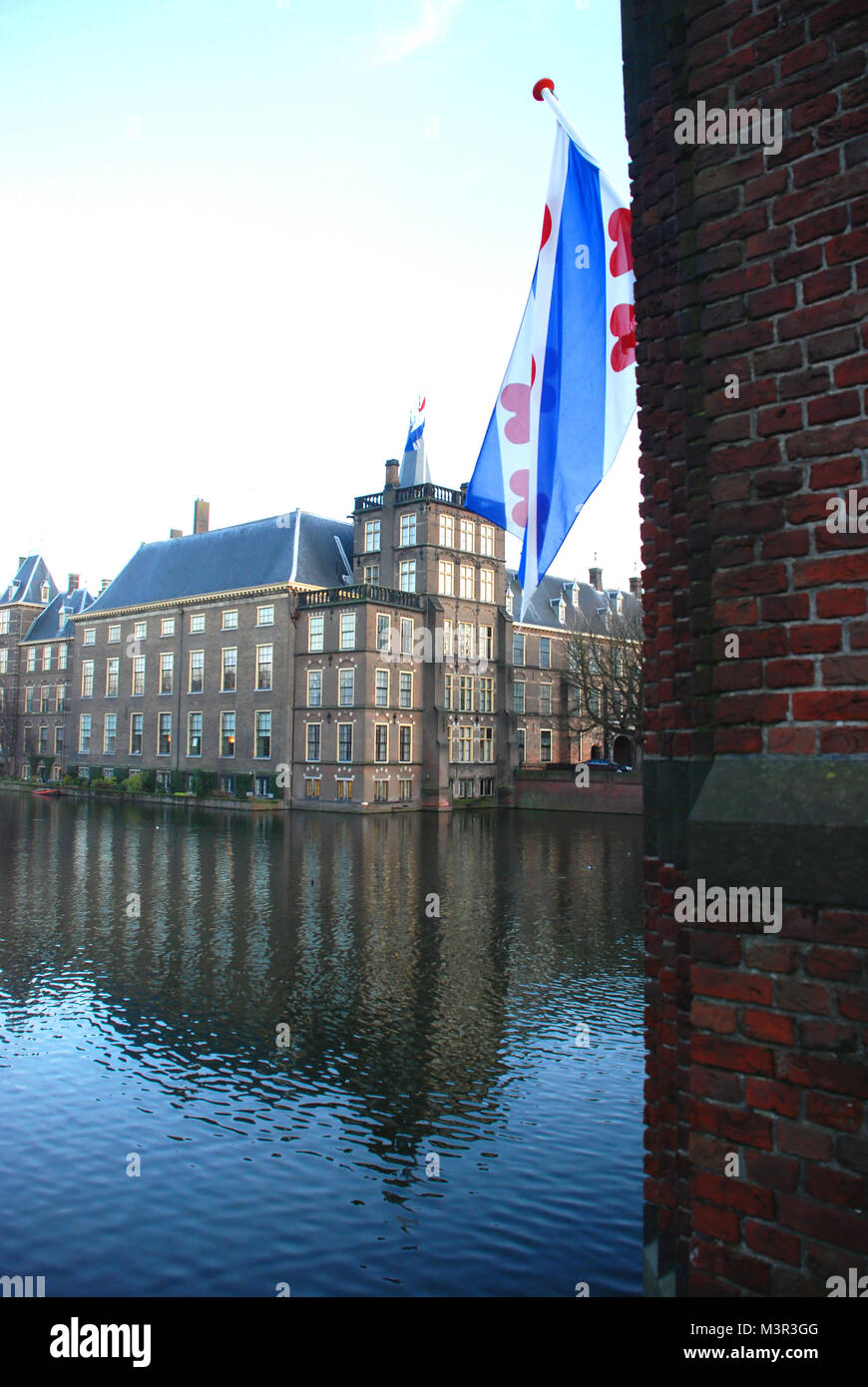 Het Binnenhof and Hofvjver Lake (Friesland flag in the foreground), the Hague, the Netherlands Stock Photo