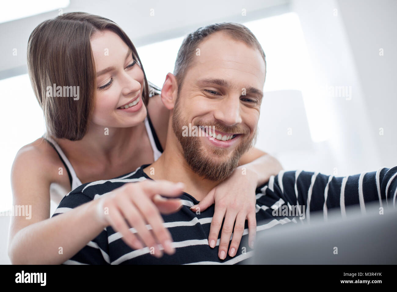 Delighted woman hugging and looking at her boyfriend Stock Photo - Alamy