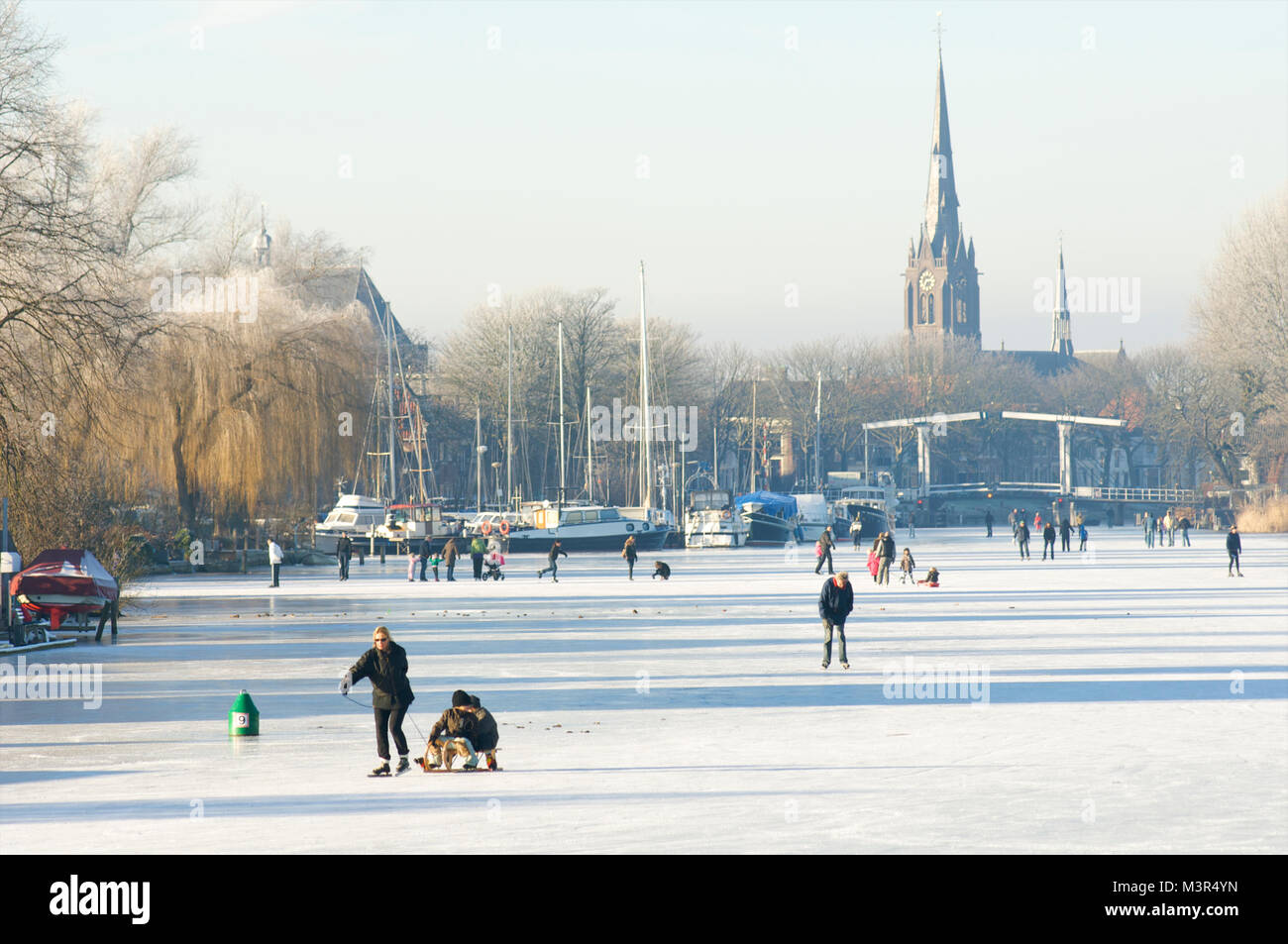 People skating on the river de Vecht with Weesp in the background, The Netherlands Stock Photo