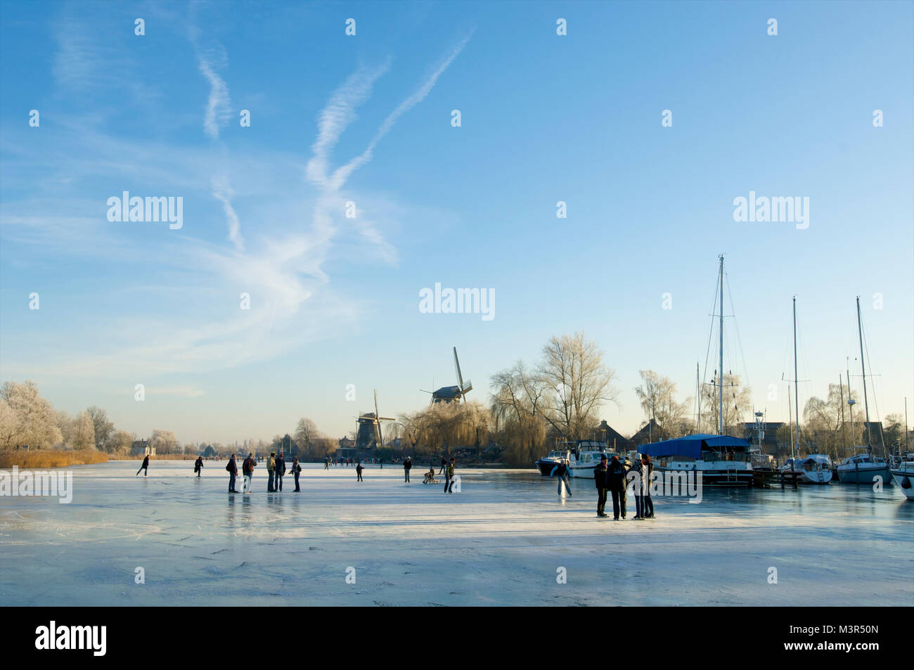 People standing on the frozen river de Vecht near Weesp, the Netherlands Stock Photo
