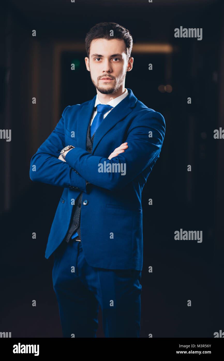 happy businessman with arms crossed standing in office Stock Photo - Alamy