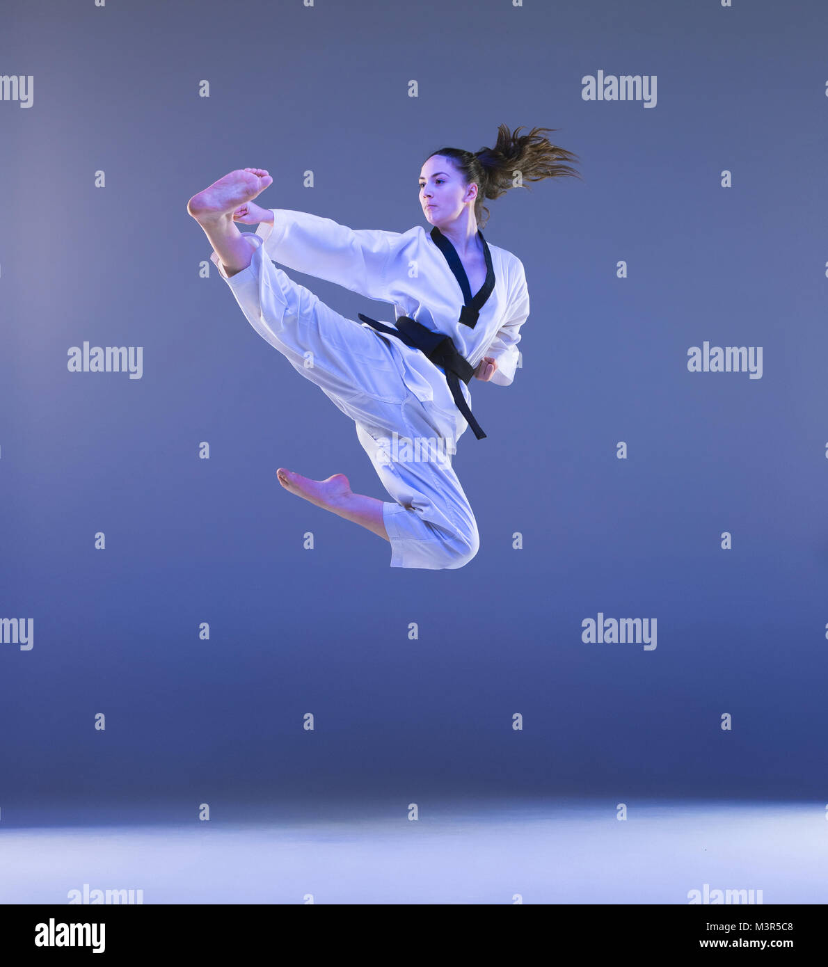 The karate girl with black belt Stock Photo