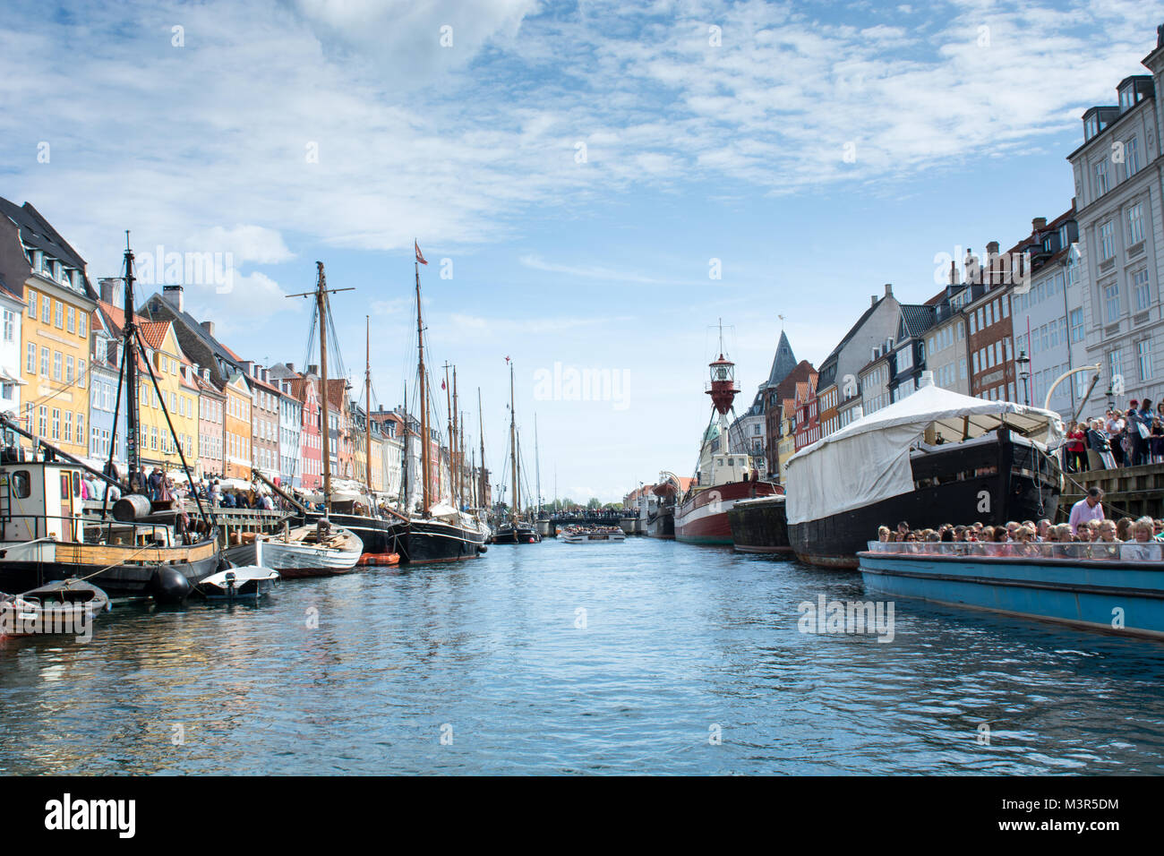 Nyhavn Copenhagen on a summer day with Netto boat and tourists on the canal tours Stock Photo
