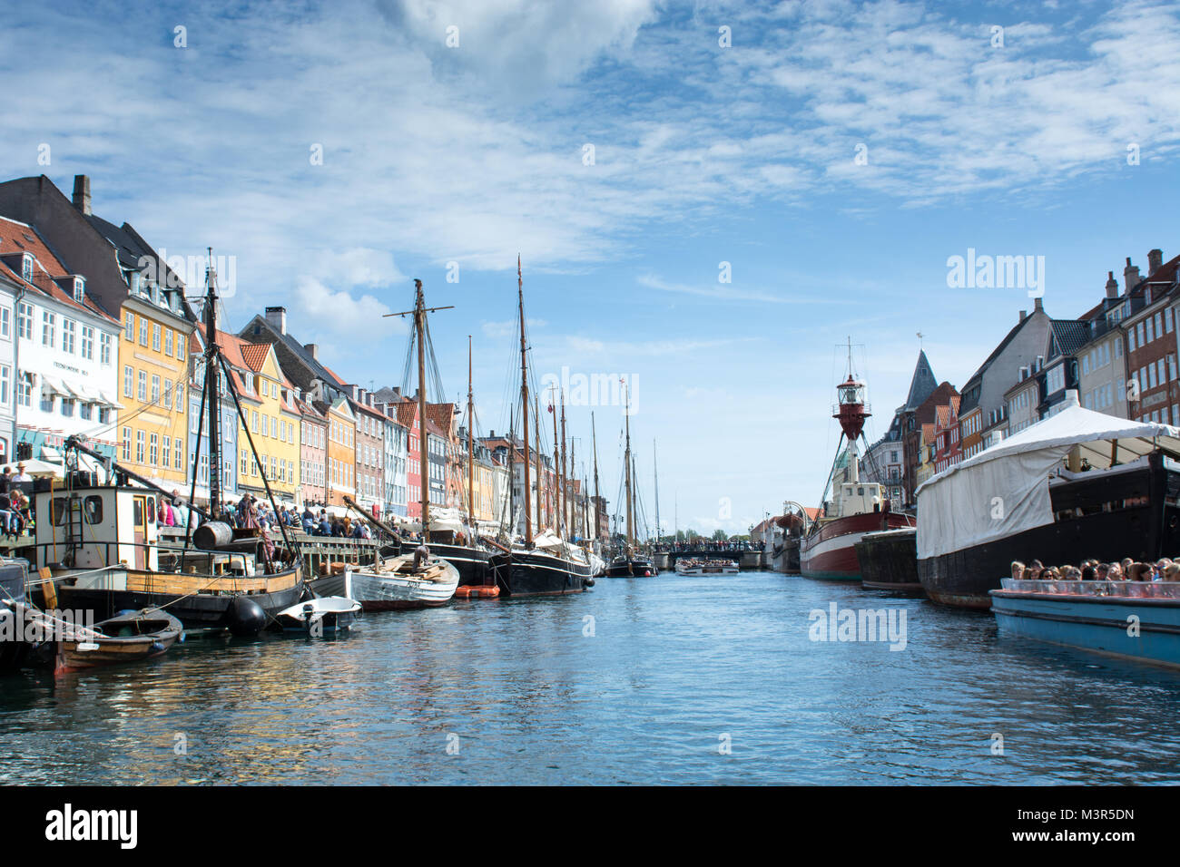 Nyhavn Copenhagen on a summer day with Netto boat and tourists on the canal tours Stock Photo