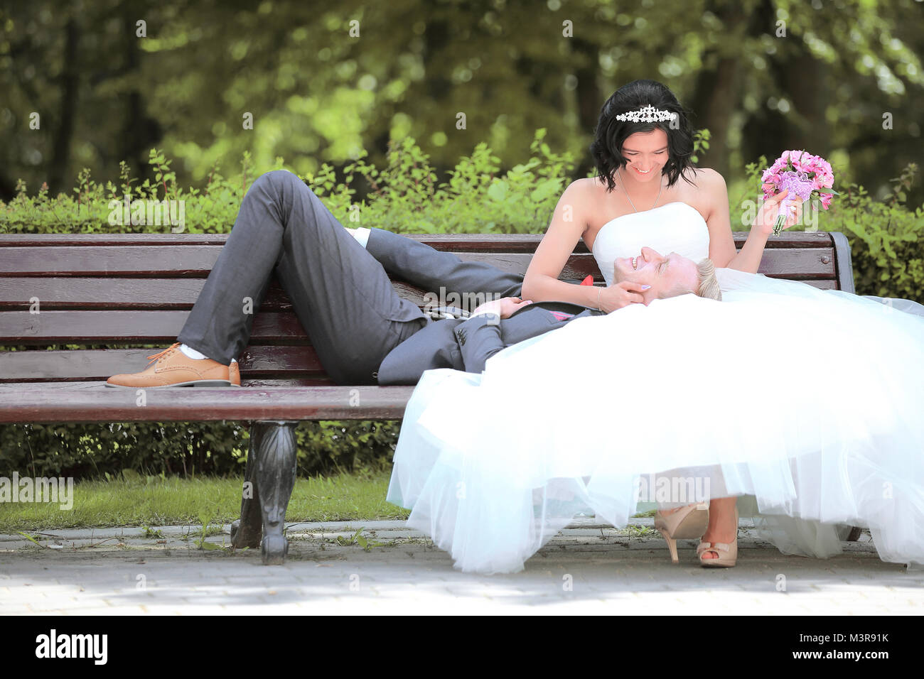 groom and bride relaxing on a Park bench Stock Photo - Alamy