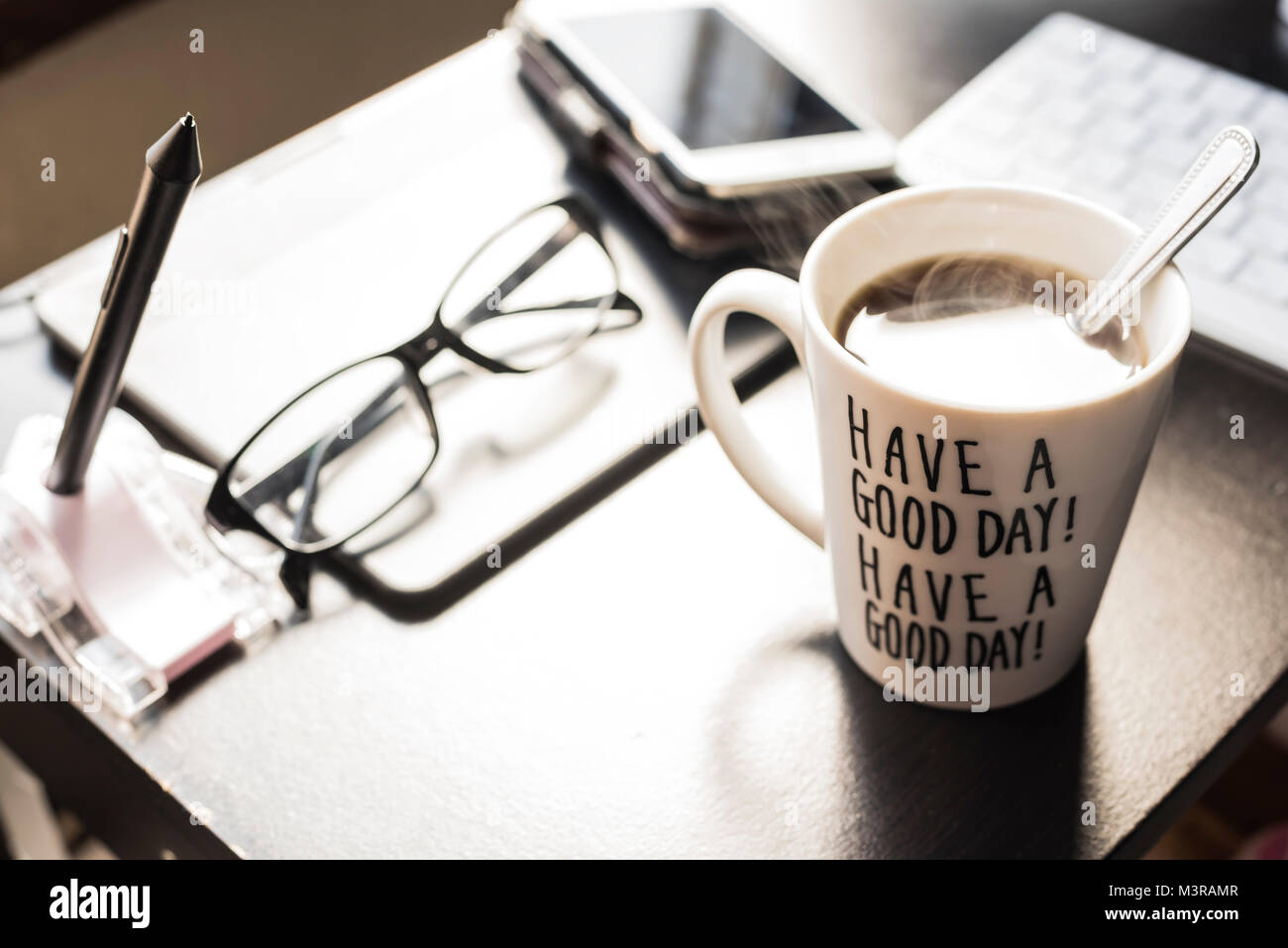 morning coffee in a mug with message &ldquo;have a good day&rdquo; on a blury
