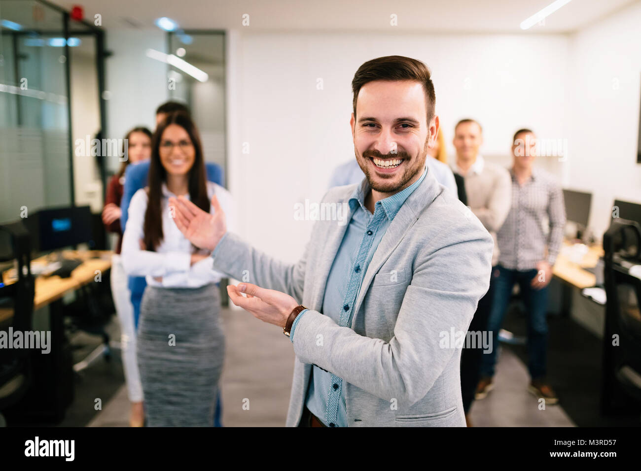 Portrait of business team posing in office Stock Photo - Alamy
