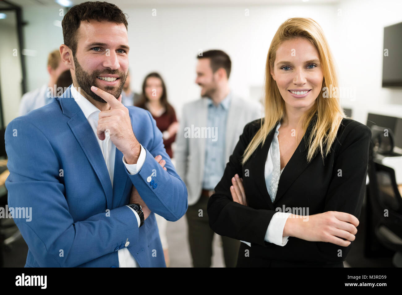 Portrait of business team posing in office Stock Photo - Alamy