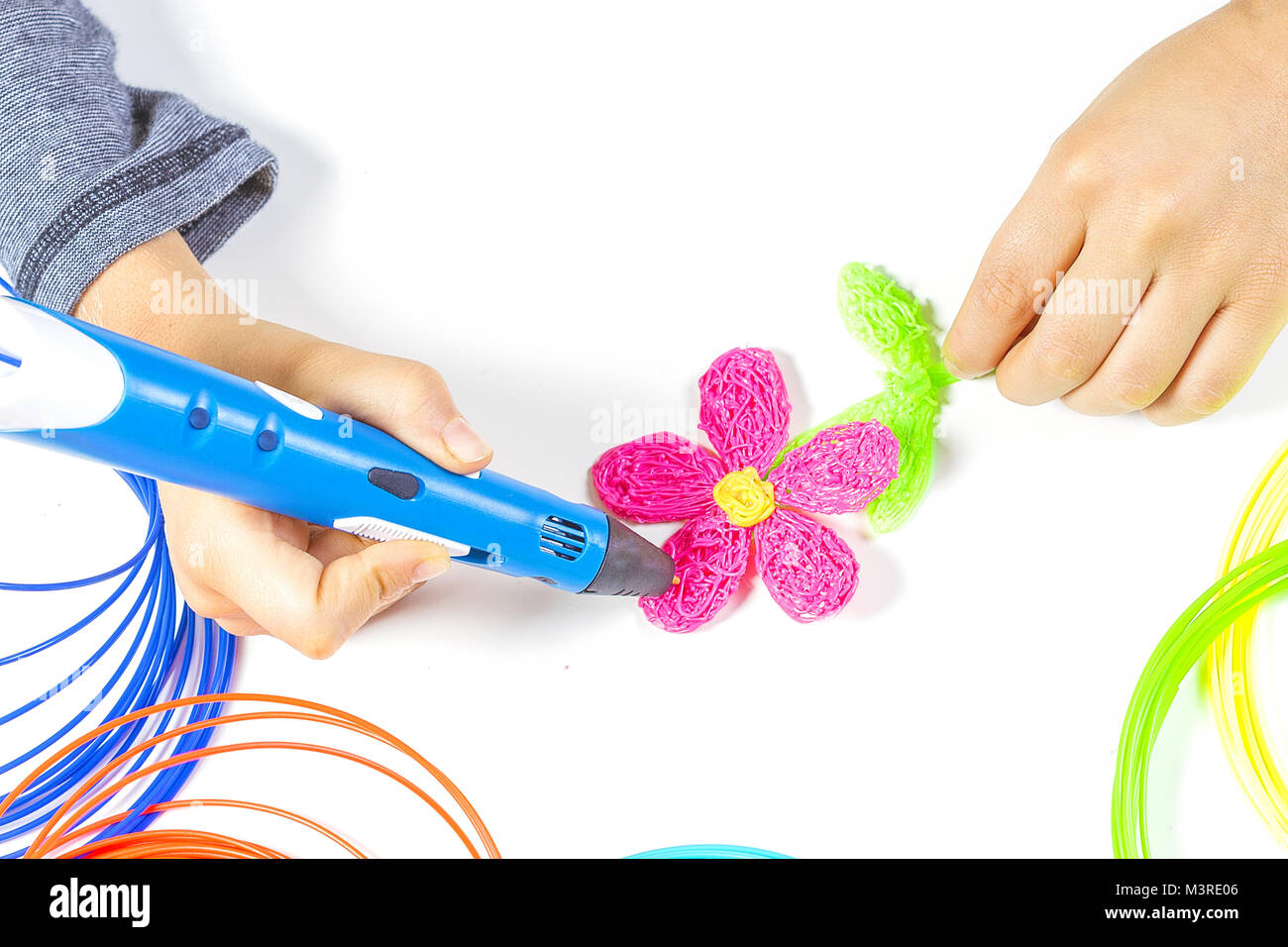 Kid hand holding blue 3d printing pen and making new item Stock Photo ...